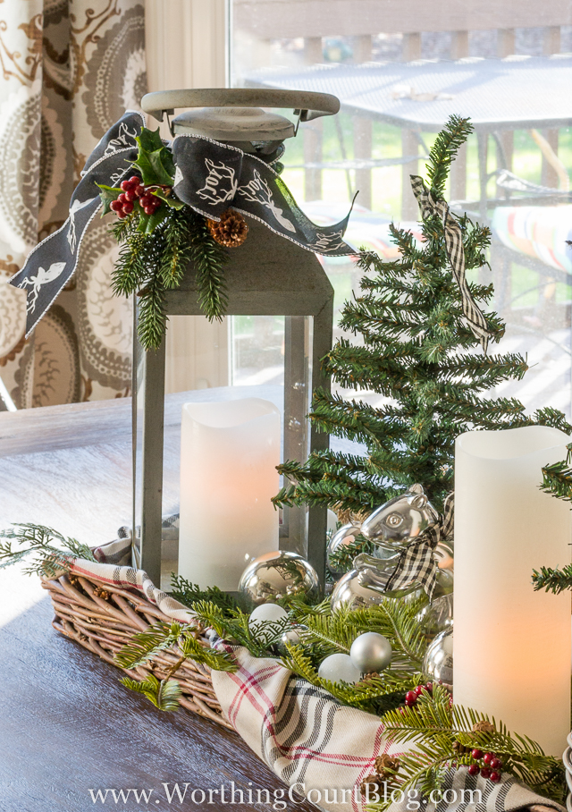You can use lanterns for the table center pieces as well. I also love the silver ornaments mixed in.