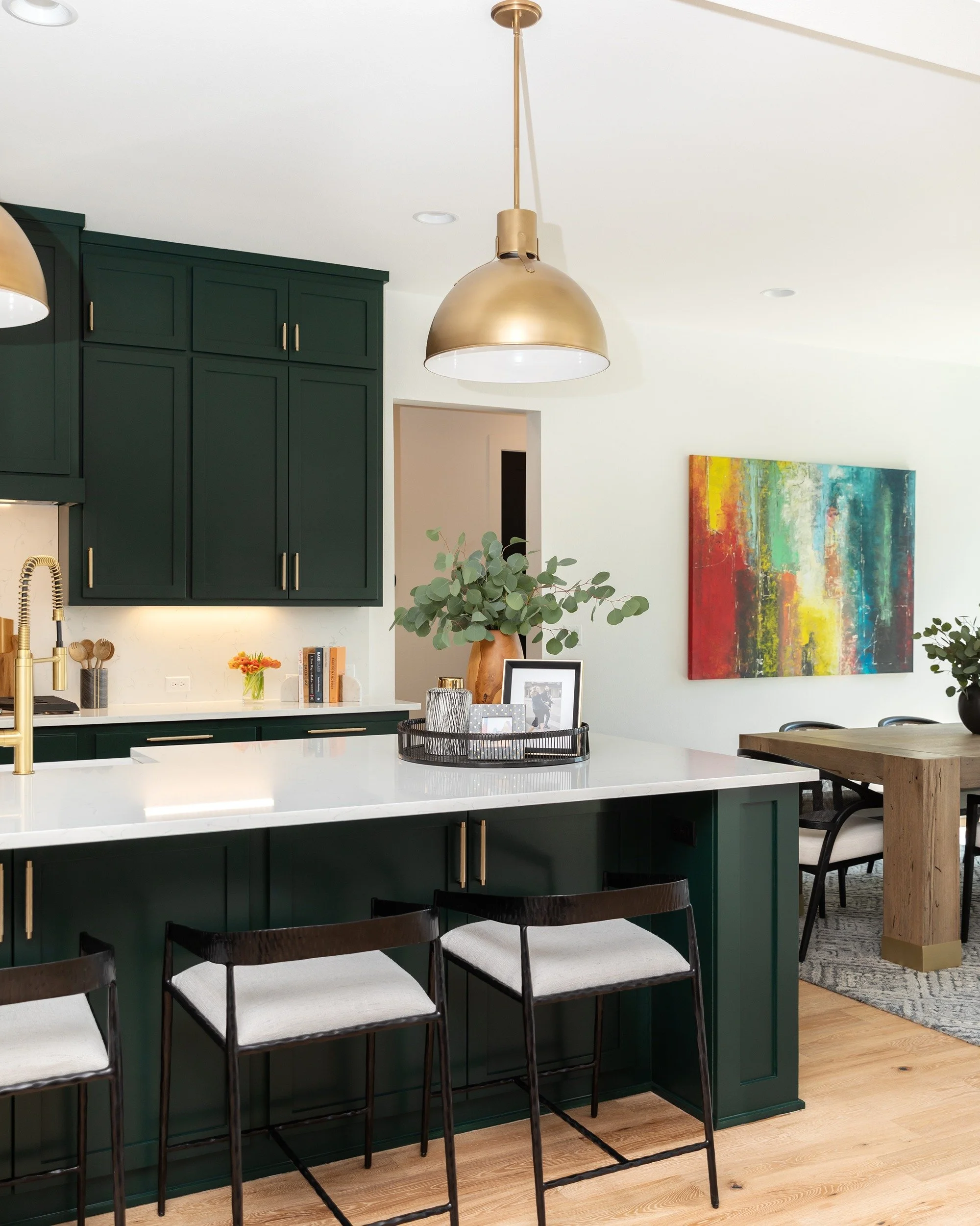 A kitchen designed to feel equal parts timeless and bold.

The deep green cabinetry brings richness and depth, while the warm brass accents add just the right amount of contrast and glow. Balanced with crisp white surfaces and natural oak flooring, t
