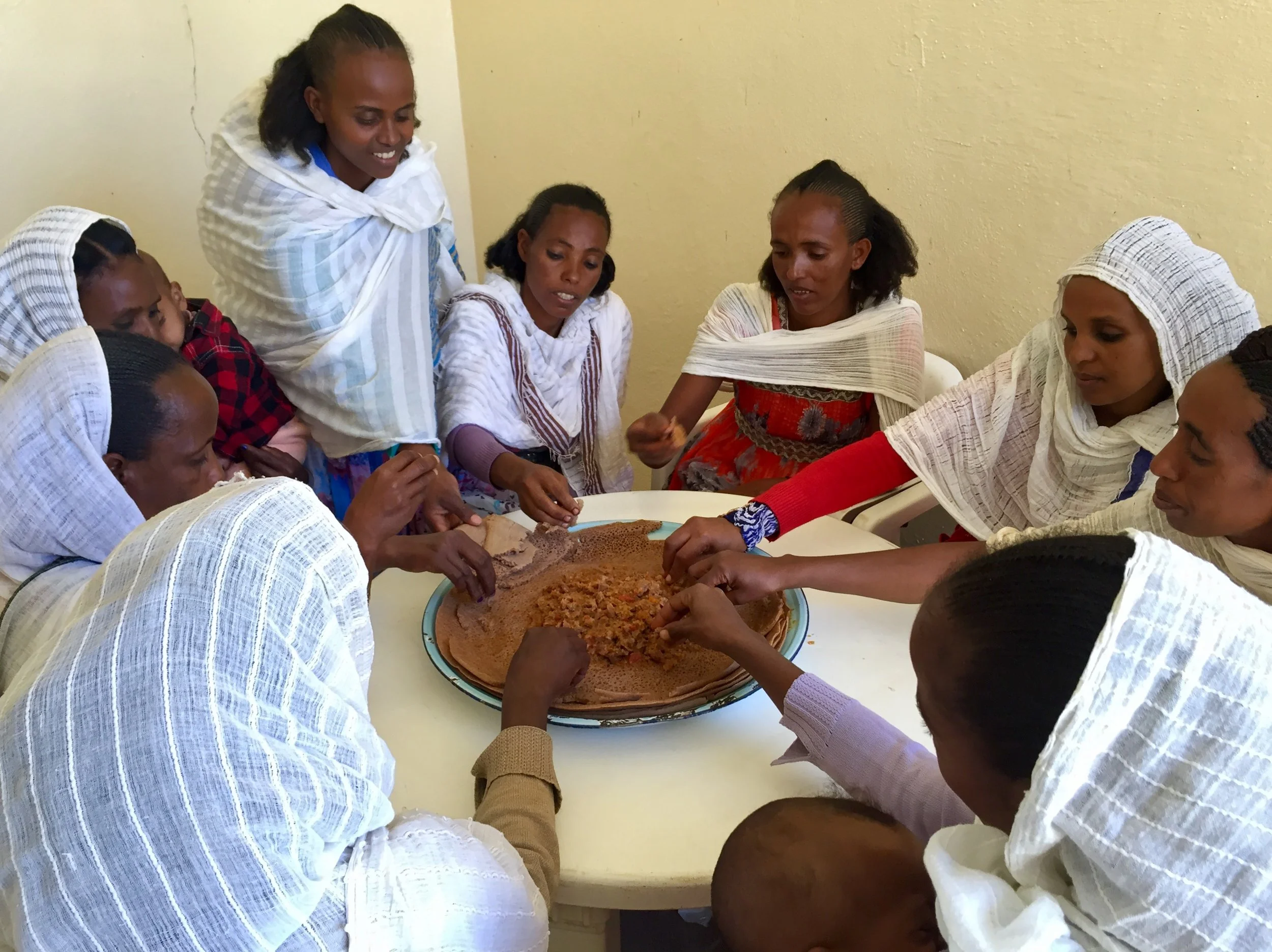Rahwa team members eating injera.