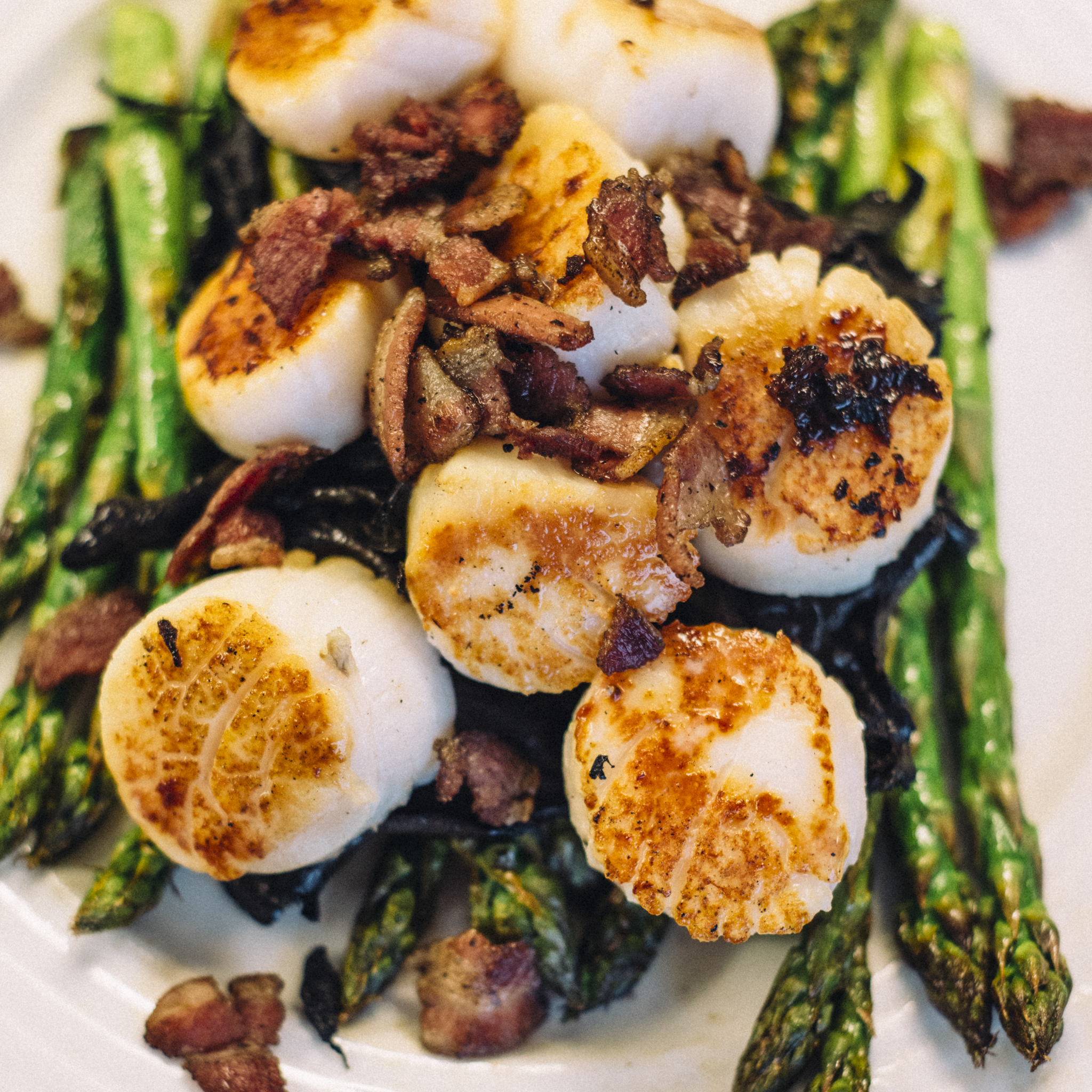 Sea scallops with pancetta on a bed of asparagus and black trumpet mushrooms with a port wine reduction glaze. It required a little timing, but everything here was prepared in the skillet shown above.