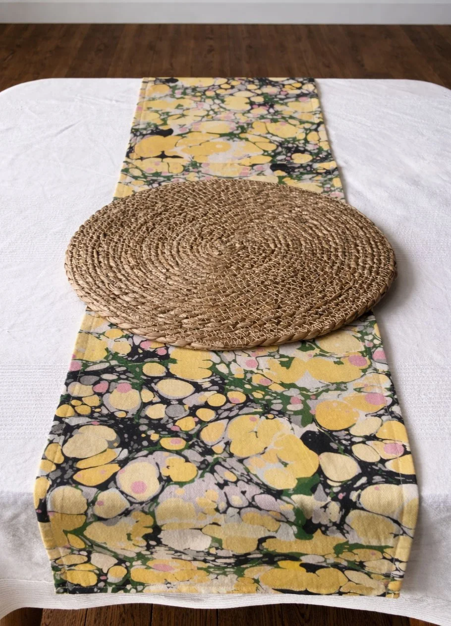 Elegant dining table with marbled table runner in green and gold tones, Italian artisan table decor