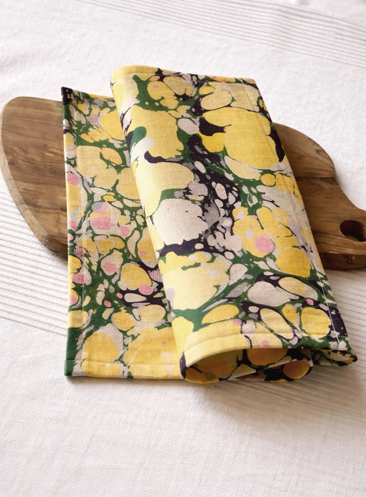 Close-up of marbled cotton canvas placemat showing woven texture and La Forestina forest-inspired pattern