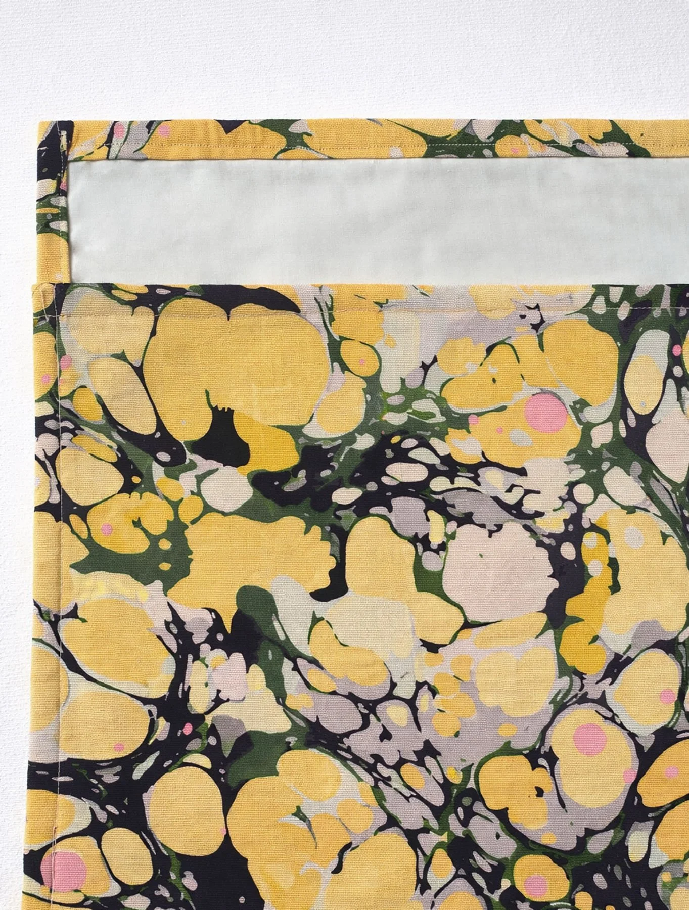 marbled placemat styled on natural linen tablecloth with soft forest-inspired tones