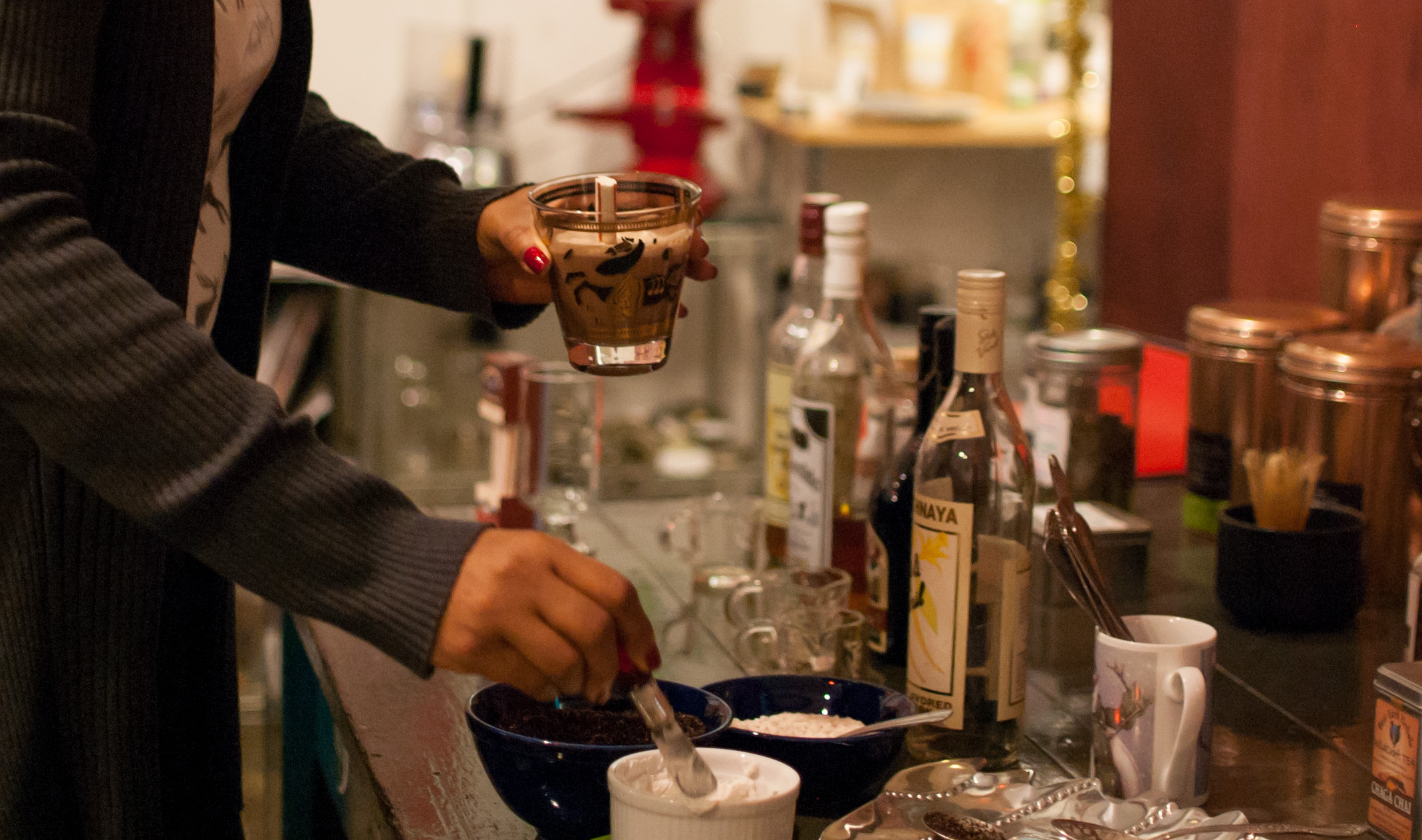 a hot cocoa bar equipped with peppermint stir sticks, crushed candy canes, cookies, coconut cream, and...booze!