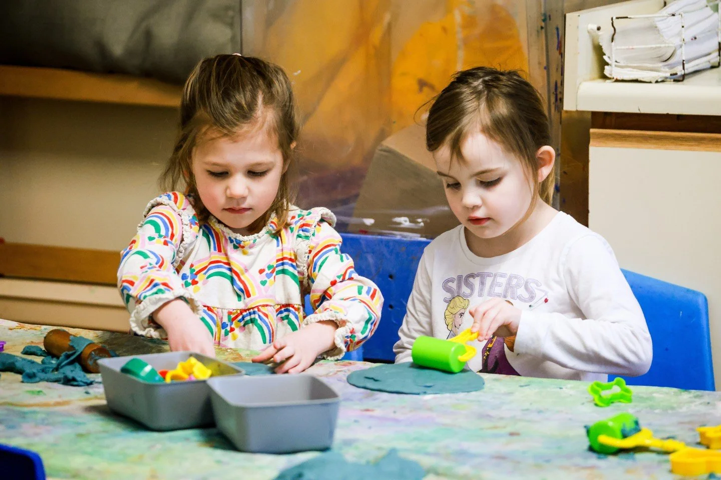 Children exploring with their hands, learning with friends, and building the strength and confidence that supports writing skills naturally.
