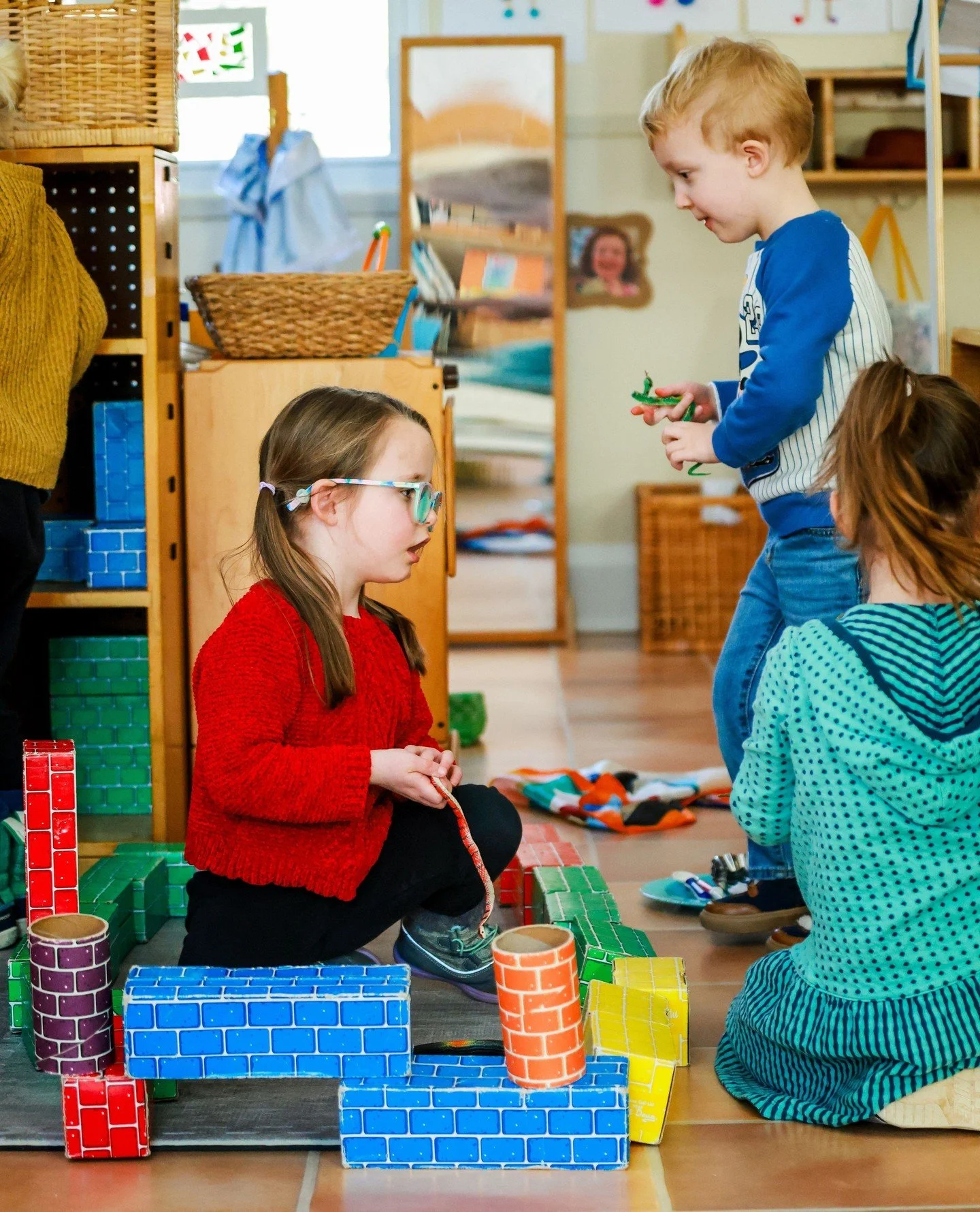 At WEEMS, collaborative tasks like building blocks or sorting objects by color, foster teamwork.