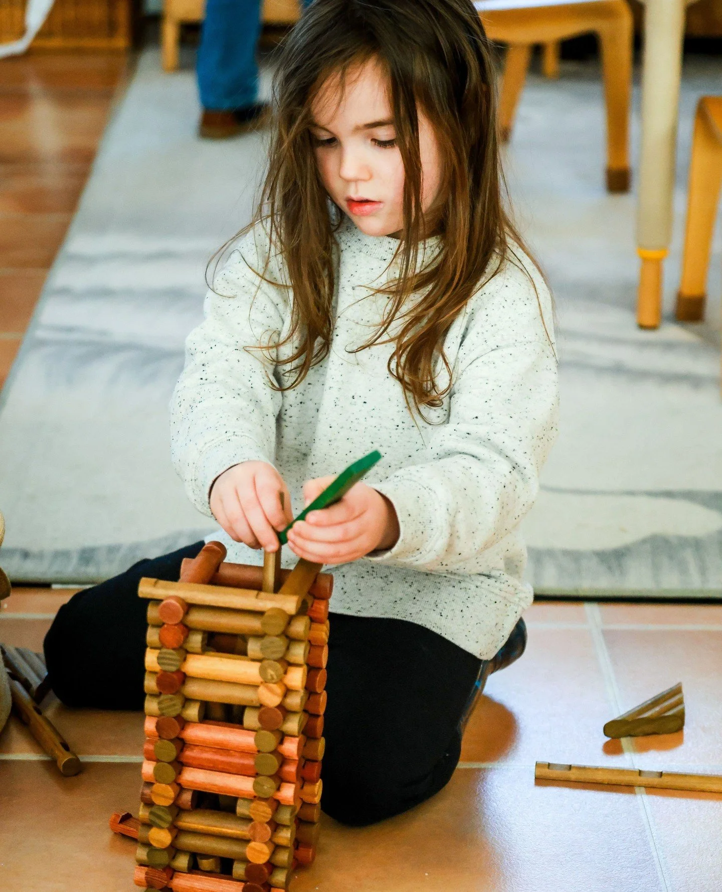 Blocks and construction toys are used to develop understanding and early physics concepts like balance, ratio, and proportion.