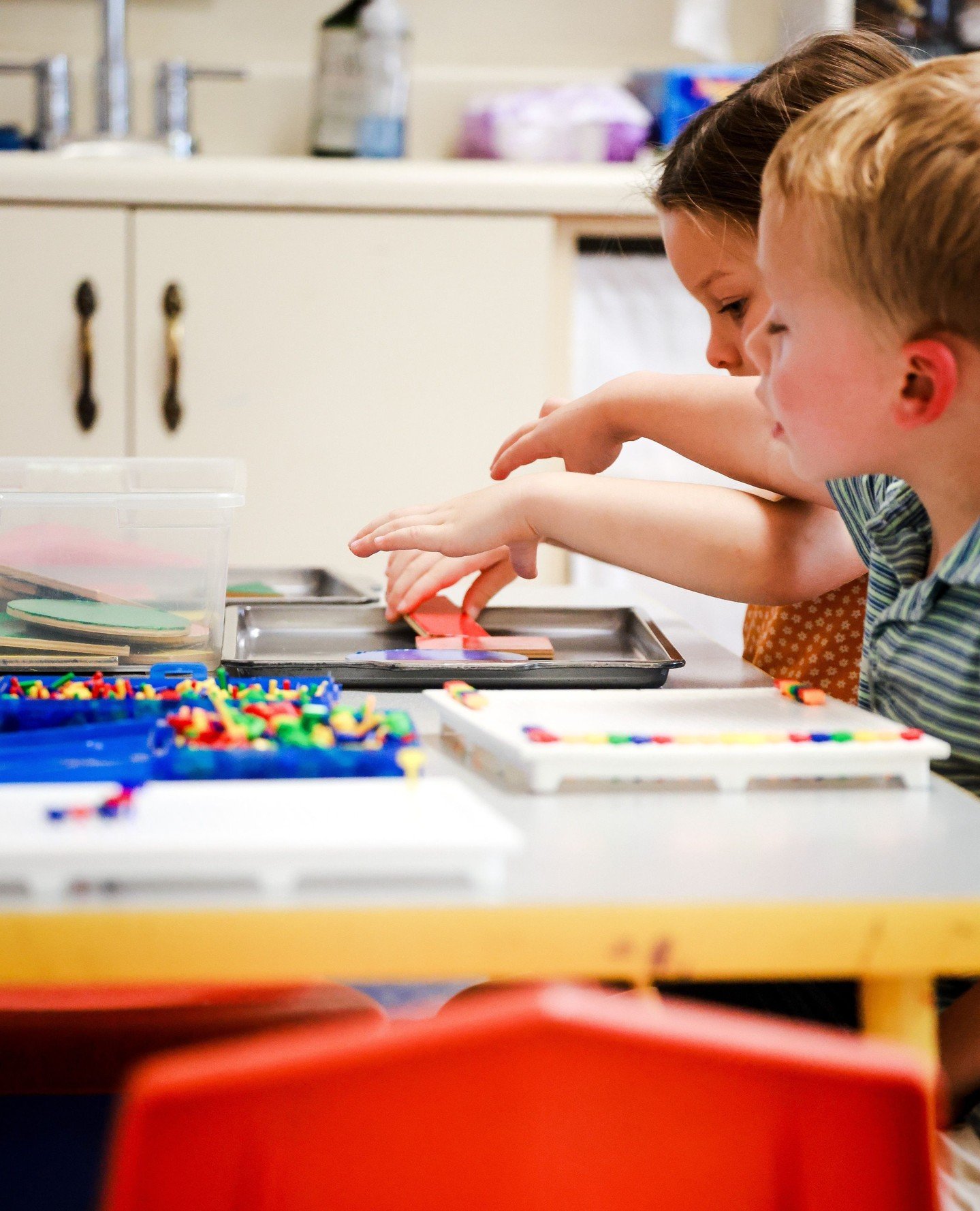 Tactile manipulative toys help children develop fine motor control, spatial awareness, and early math skills through hands-on sensory exploration in a responsive classroom.