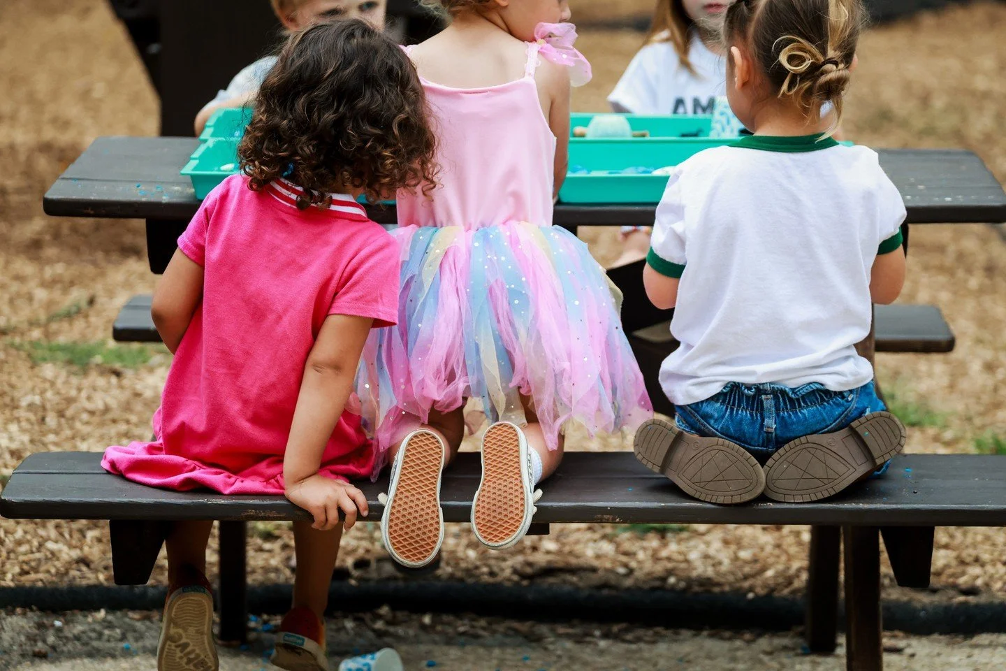 Sharing a surface encourages kids to notice others' feelings, wait their turn for supplies, and respect personal boundaries.