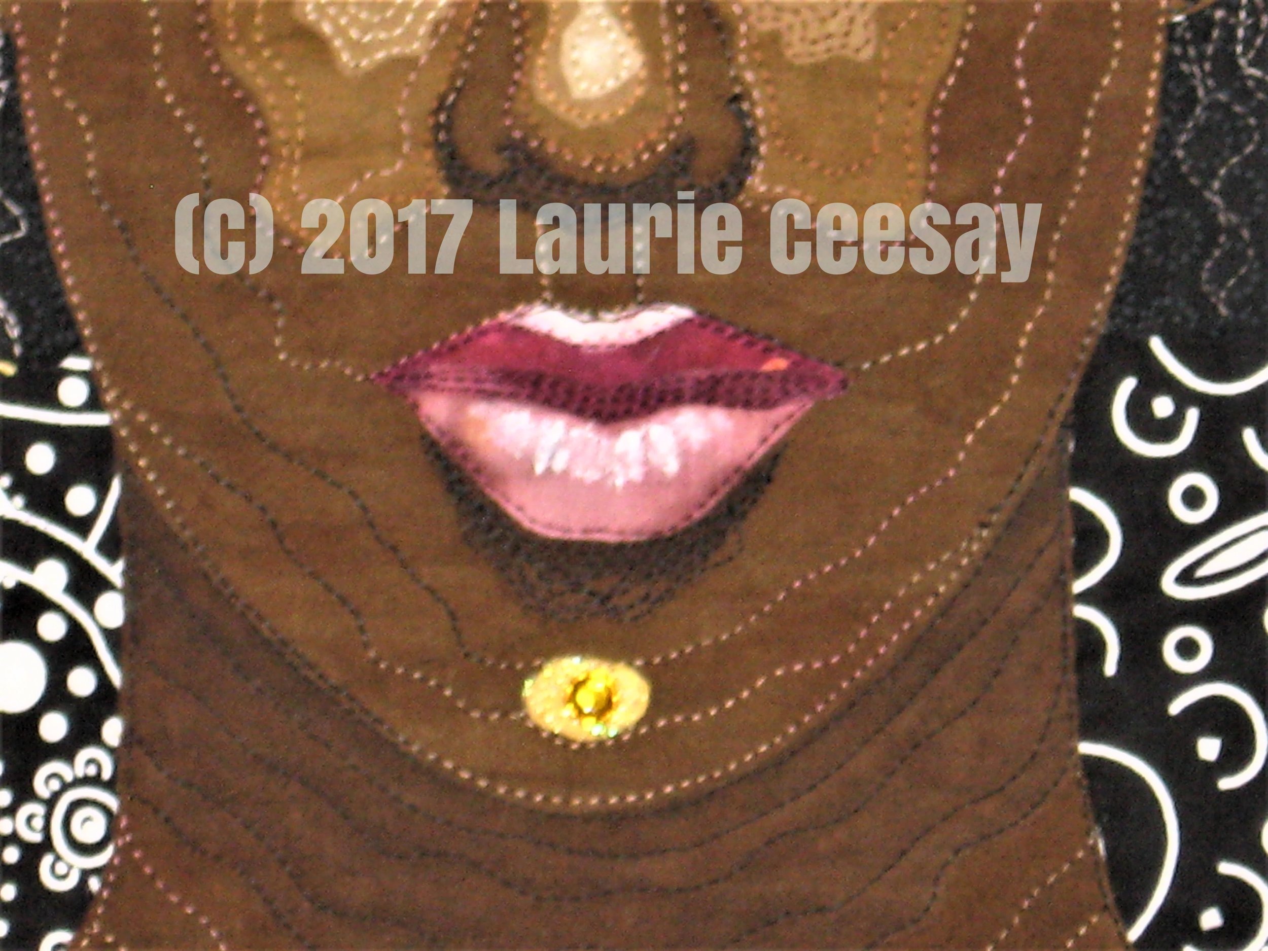 Photo of the mouth detail using Inktense pencils for shadowing and white fabric paint for highlighting. Thread painting adds to the depth of the mouth. The next project due July 31st is Nursery Rhythms with a twist of a back story. I am leaning towards a co-dependent lamb who follows Mary around! Snort!