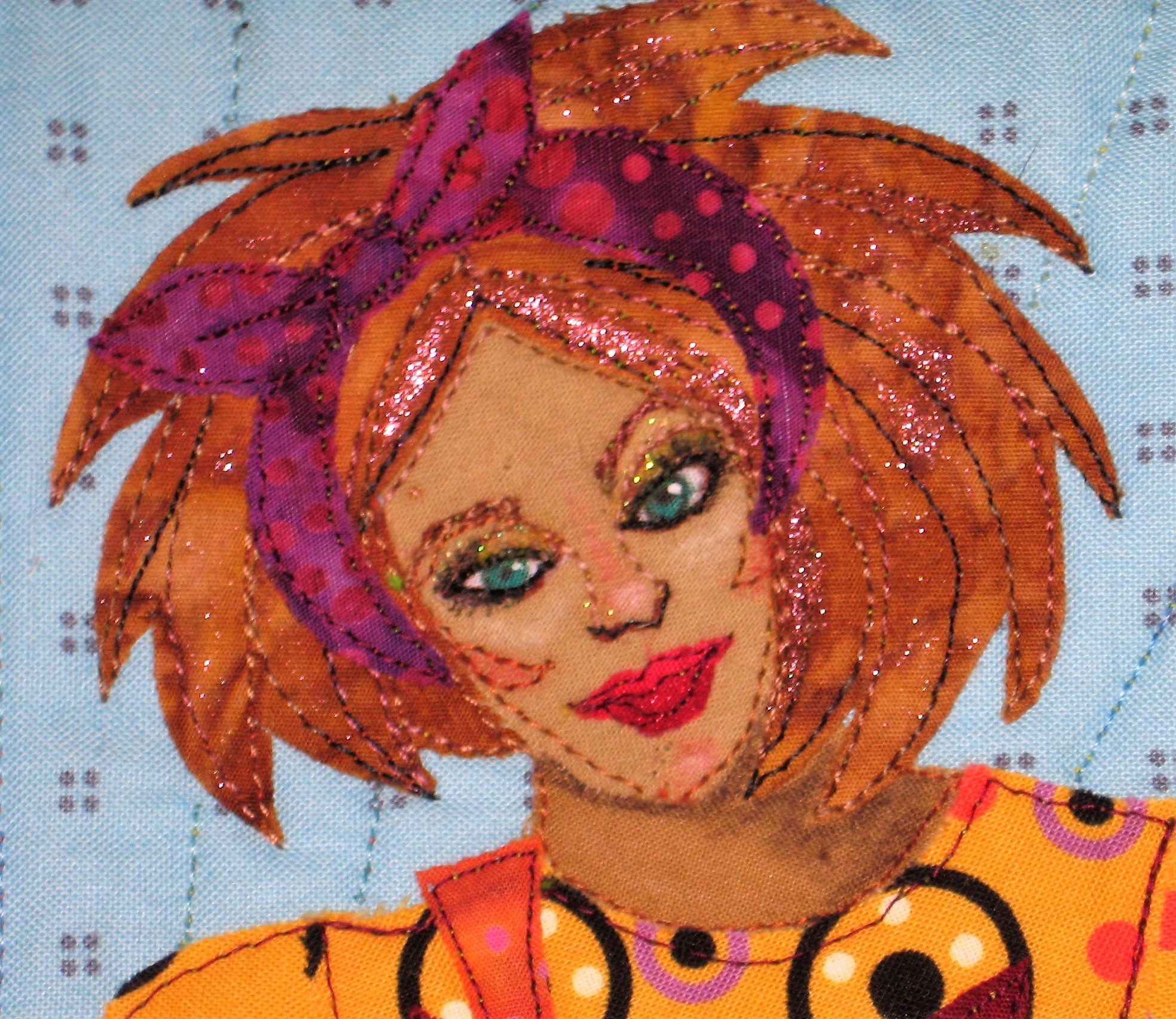 Mary's face is very small at 1" wide by 1.5" tall. I cut tiny white batik eyes and a red mouth and fused them on the face. I used fabric markers, paint, colored pencils and thread painting to get the facial details. I embellished with glitter nail polish and fabric paint. The hair received some bronzy nail polish as high lights. It was challenging to get such detail on the small scale.