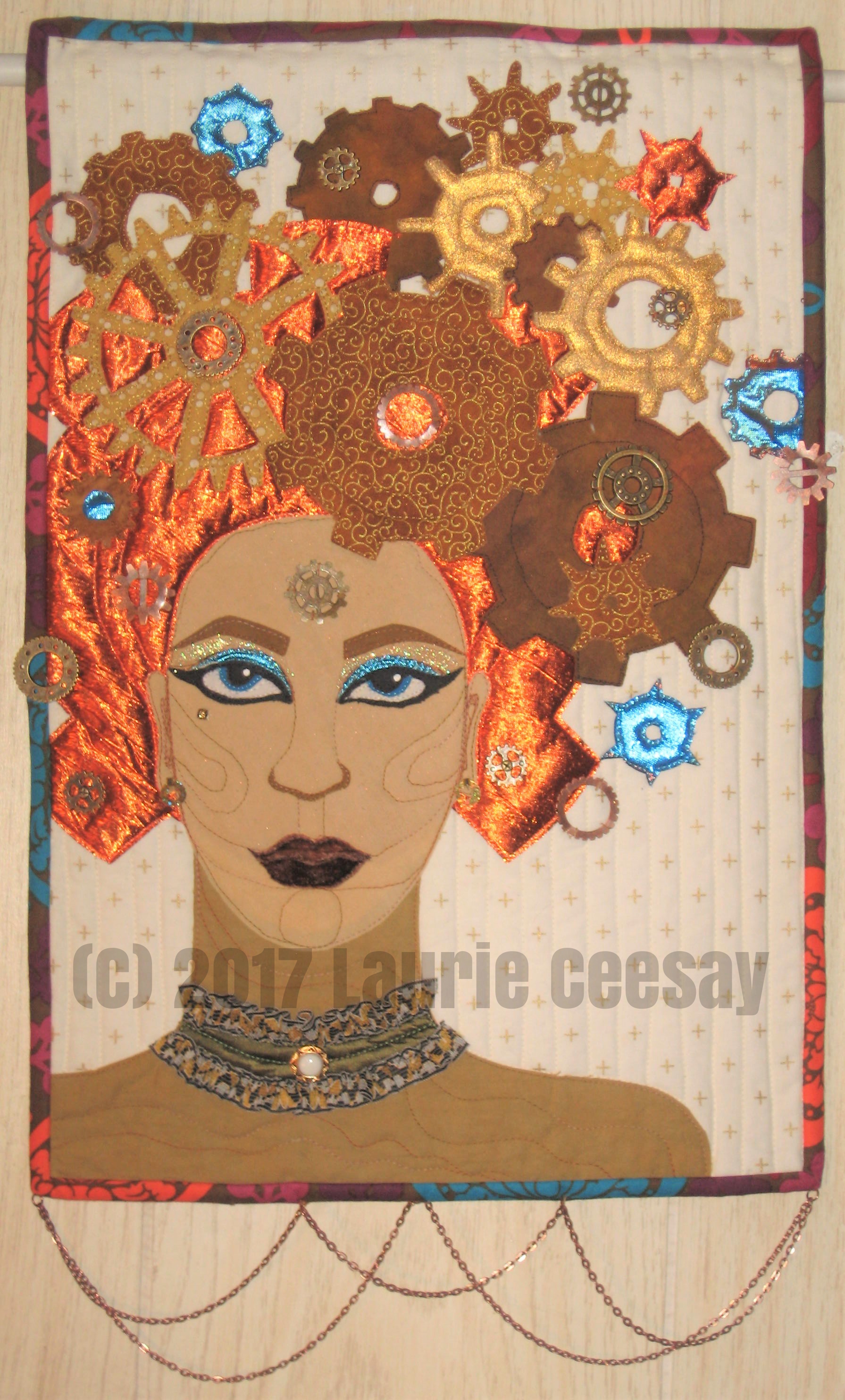 Today is reveal day for my Facebook Art quilt group Art Quilts Around The World. There are 20 artists literally from all over the world and I have met none of them. The group has had a huge change in membership and the current group of 20 people seem to be excited about producing a small challenge quilt every other month which was not the case in the past. This challenge is Steampunk which isn't really a challenge since it is one of my favorite things! I have a Pinterest board devoted to steampunk fashions. I already made a larger more detailed steampunk quilt which is at the bottom of this post in which I used a variety of lames. velvets, gears and repurposed jewelry. This quilt has been entered in various quilt shows and has won a few awards. I decided to use the same turquoise and orange color scheme as the first quilt but simplify it. No garment or hat due to size restrictions. I chose to have a variety of gears in a variety of colors, textures and fabrics as the portrait hair. I call it "Gear Head!" I Googled clip art of gears to get the different shapes and sizes of gears and just started placing and fusing.