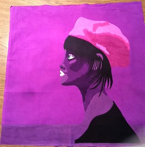 This is the quilt with the fused applique in place. I used black for the hair because Prince's wives, girlfriends and females in his videos and movies all had brunette or black hair-no blondes. I used black for the garment as well. I was wishing for more variation of value with the purples such as a lilac. I decided to add lighter areas with thread painting.