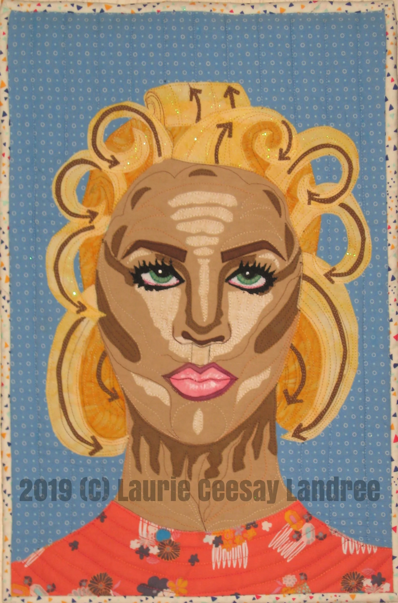 Today is reveal day for my Facebook art quilt group’s bimonthly challenge. The theme was Step By Step. I thought of makeup and hair lessons or tutorials. I was a huge fan of Kevin Aucoin, a makeup artist for celebrities, who wrote 3 wonderful makeup books yet passed away from prescription drug overuse in the early 2000s. He would photograph women with their makeup NOT blended to show how and where to apply and which colors to use. The hair tutorial reminds me of my beauty school text book diagrams to show the location and direction of curls. These diagrams used arrows to help cosmetologist understand the direction and movement of the individual curls. When I finished this quilt I realized how crazy it looked and how it is important to blend your makeup or you will look like this!! Even the dark lipliner looks bad to me! I over-accentuated the shape or the eye brow to explain how to create an eye arch but the female in the quilt looks kind of mean. I always have my portrait quilts looking pretty so this one is kind of weird but it fit the Step by Step theme.