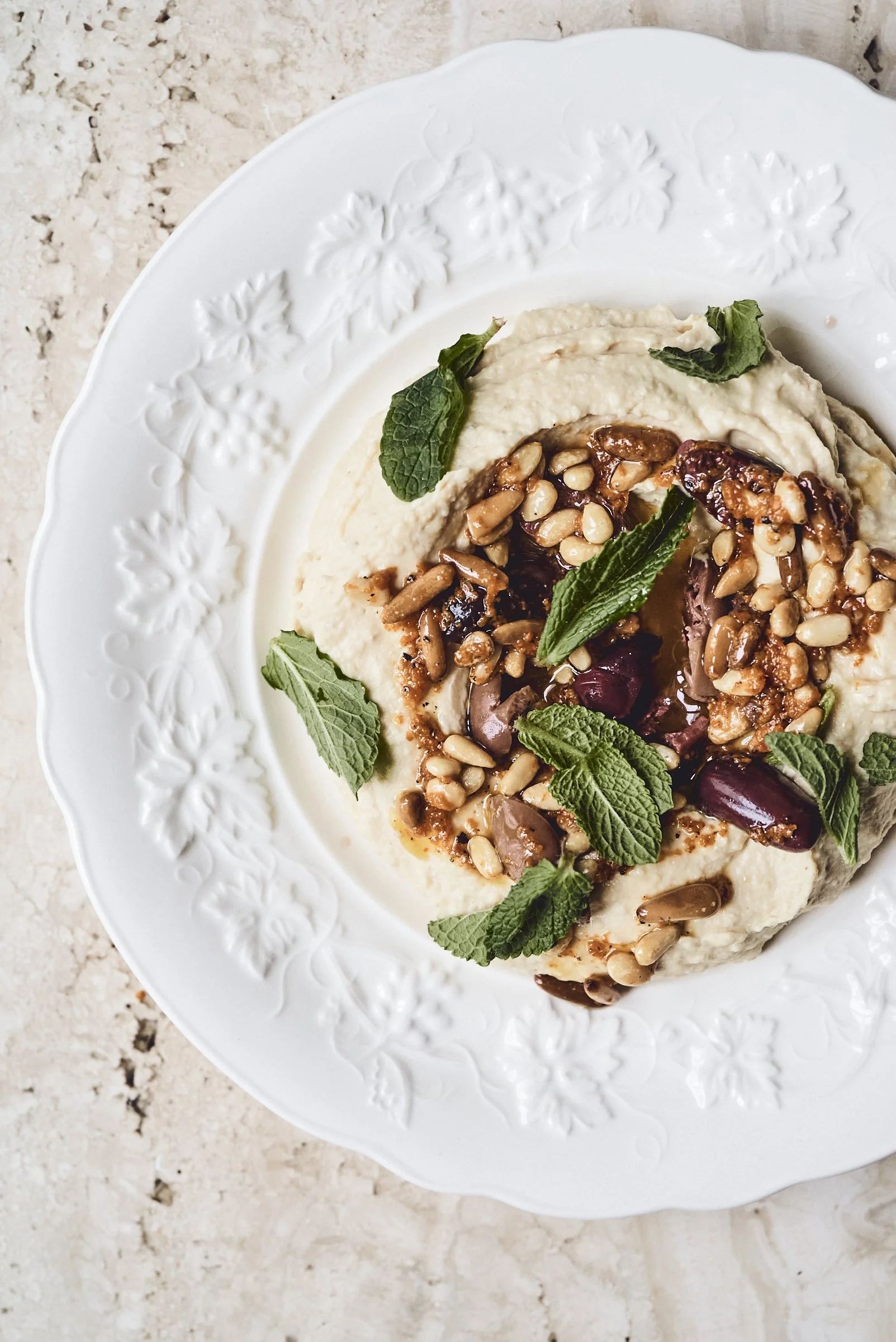 hummus with olive oil and pine nut sauce