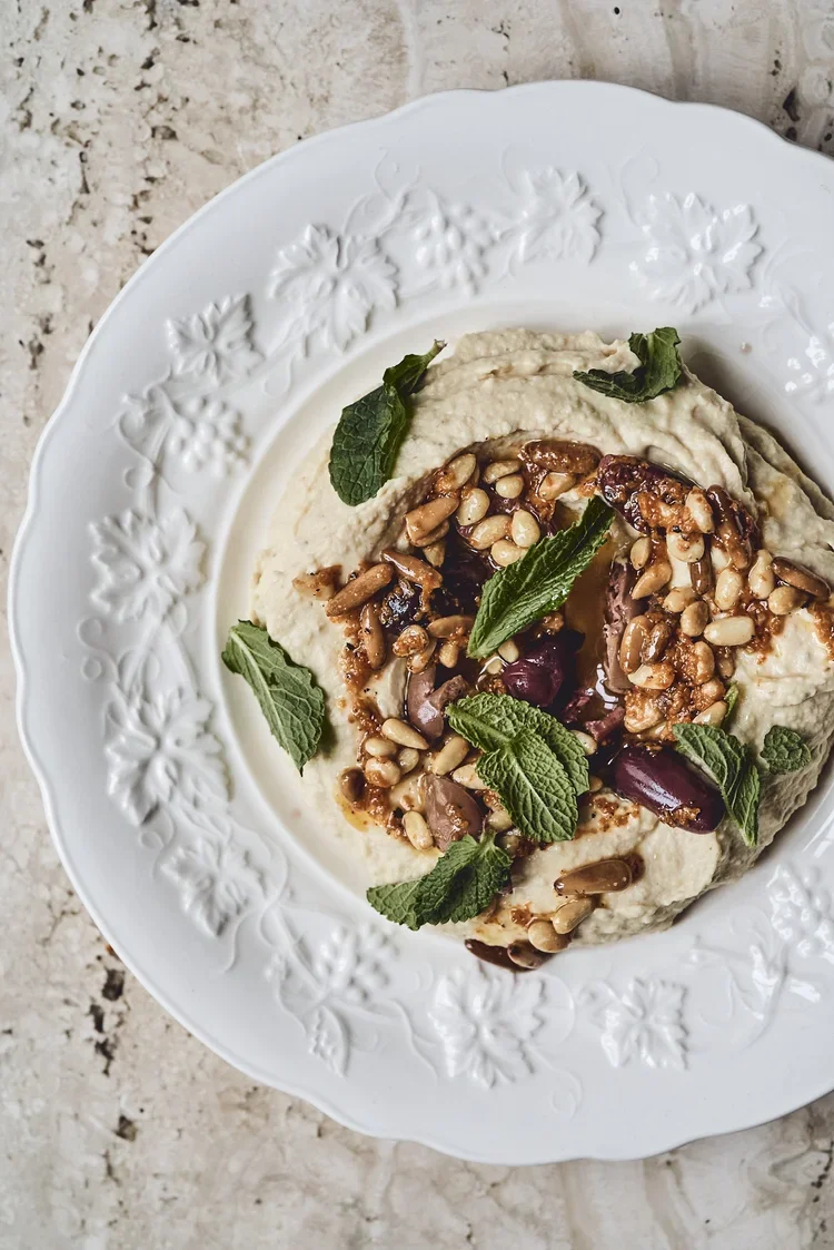 Hummus with olive oil and pine nut sauce