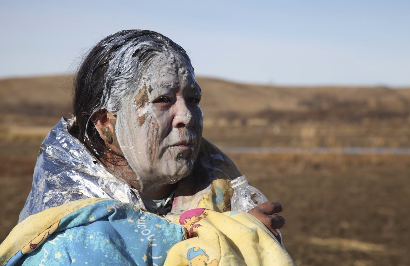 John L. Monroe/AP image taken from NPR This is an image of Tonya Stands Recovering from being pepper sprayed by police. Stands and other protesters swam across a creek hoping to peacefully block construction of the Dakota Access Pipeline. The Dakota Access Pipeline has been highly protested and contested since its proposal in June of 2016 because the natural gas pipeline is to built on sacred tribal land and negatively impact the Missouri River, which is also the main water source for the Standing Rock Reservation. The story of the Dakota Access Pipeline is not unique it is a centuries-old fight for indigenous people to protect the land and their rights from colonizers.
