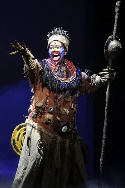 “Actress Buyi Zama as Rafiki in Taiwan” by The Lion King’s Taiwan staff is licensed under CC BY-SA 3.0