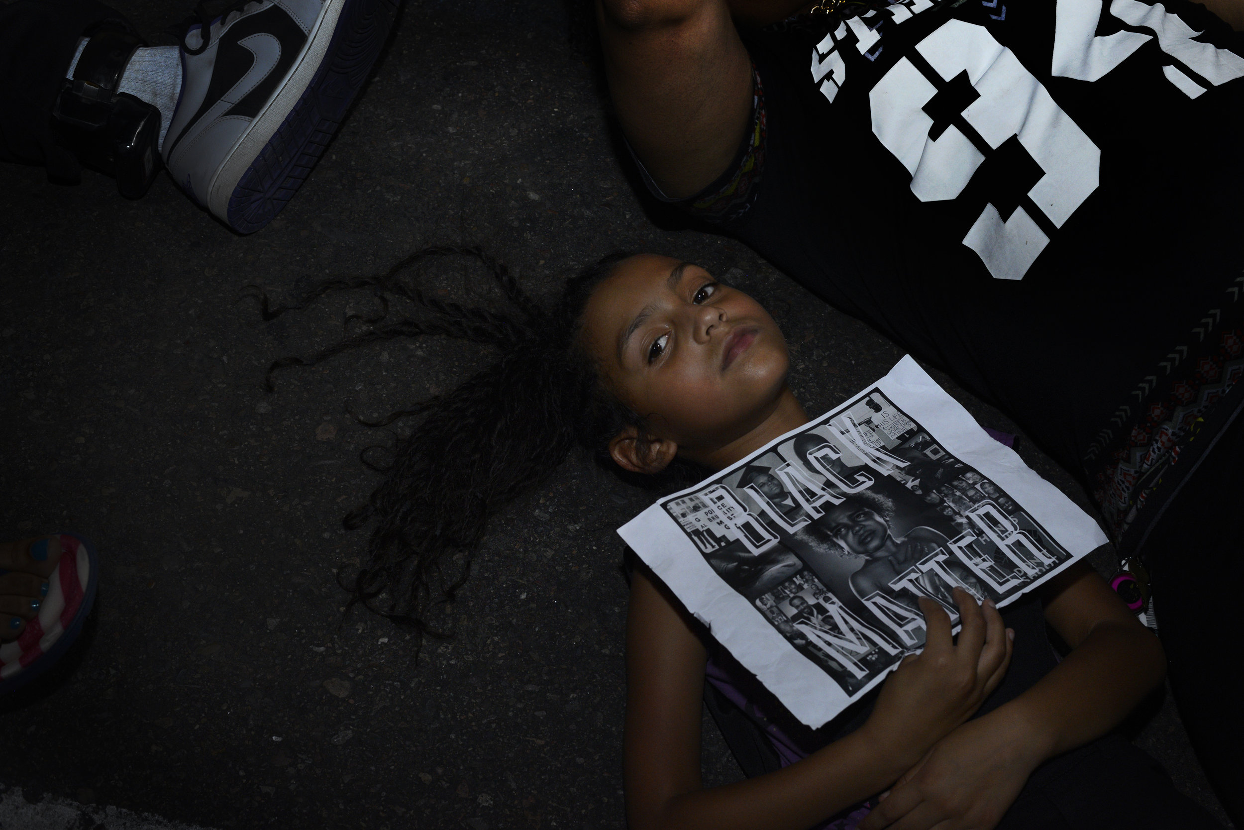  Navanna Washington lays on the street with her mother during the "Rally for Justice"&nbsp;on Friday, July 8, 2016, in Phoenix,&nbsp;Arizona.&nbsp;Several hundred people marched on downtown streets to protest the recent fatal shootings of black men b