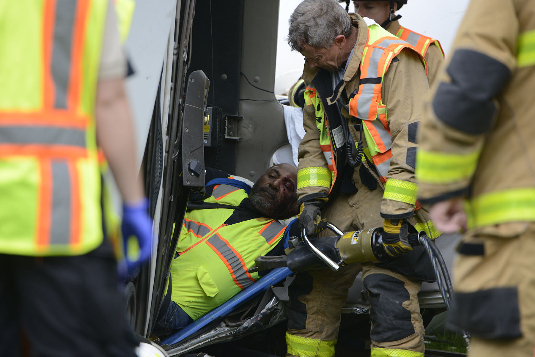  Columbia Fire Department Capt. Larry Curtis uses a Jaws of Life hydraulic cutter to remove the dashboard and steering wheel of an overturned Boone Quarries cement truck on S. Old Mill Creek Road in Columbia on June 1, 2015. The dashboard and steerin