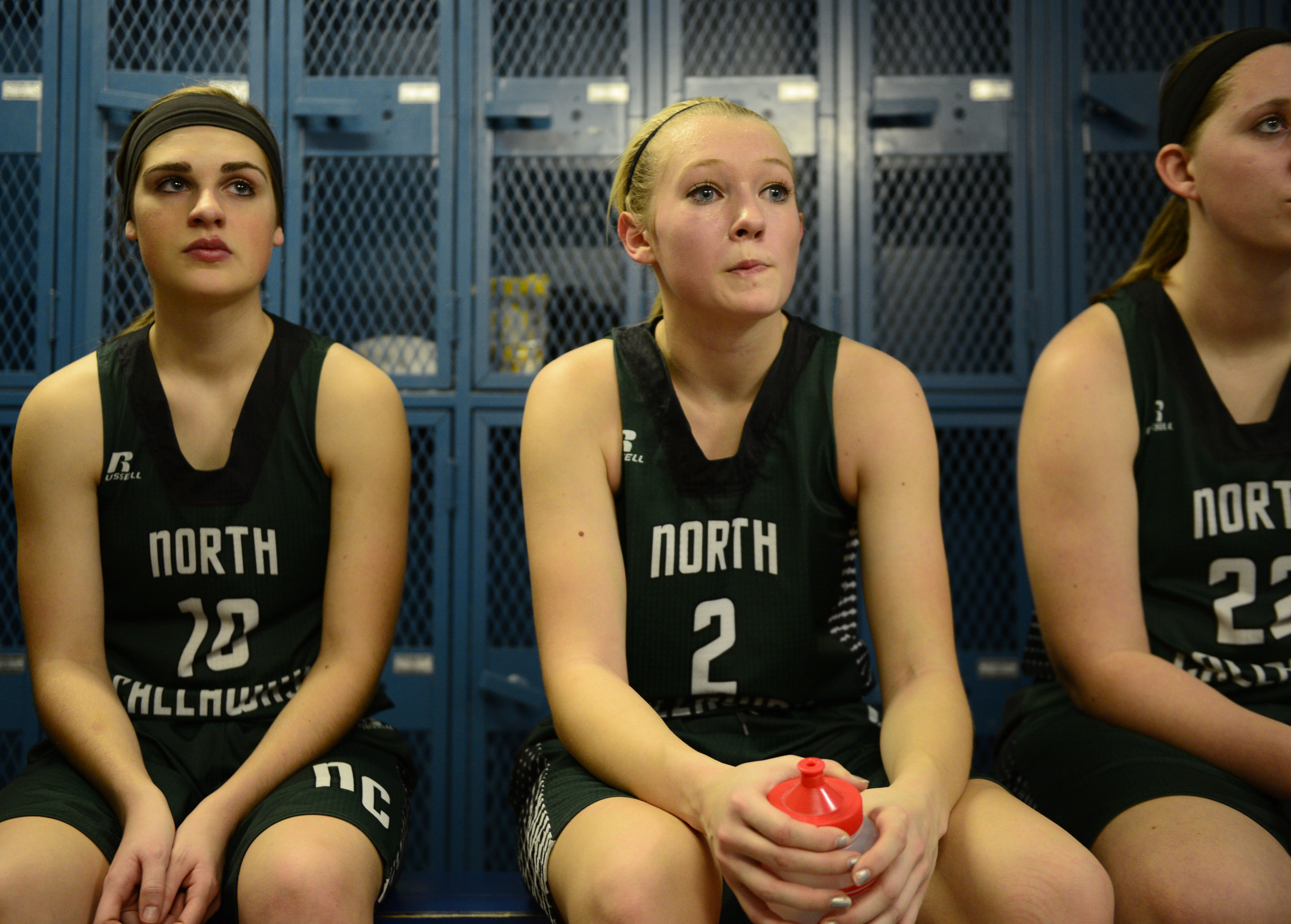  After a neck-and-neck first half, freshman Mackenzie Ausfahl sits flanked by Skylar Schmauch and Taylor Wiseman as Coach Mathias Miller gives the team some stern words in Center, Missouri, on Feb. 16, 2016. Her sister, Madison, is a senior on the te