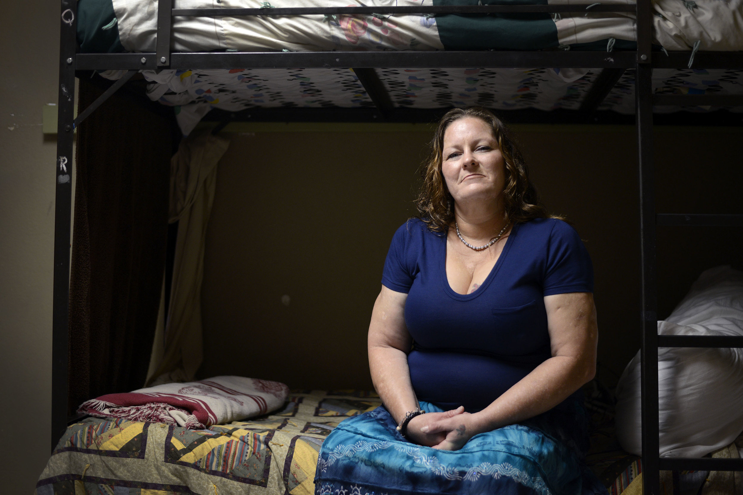  Susan Contreras sits on her bed in a Phoenix-area shelter for victims of domestic violence on Wednesday, Aug. 3, 2016. Contreras is part of a unique program at the Barrow Neurological Institute in Phoenix that aims to assist abuse survivors who have