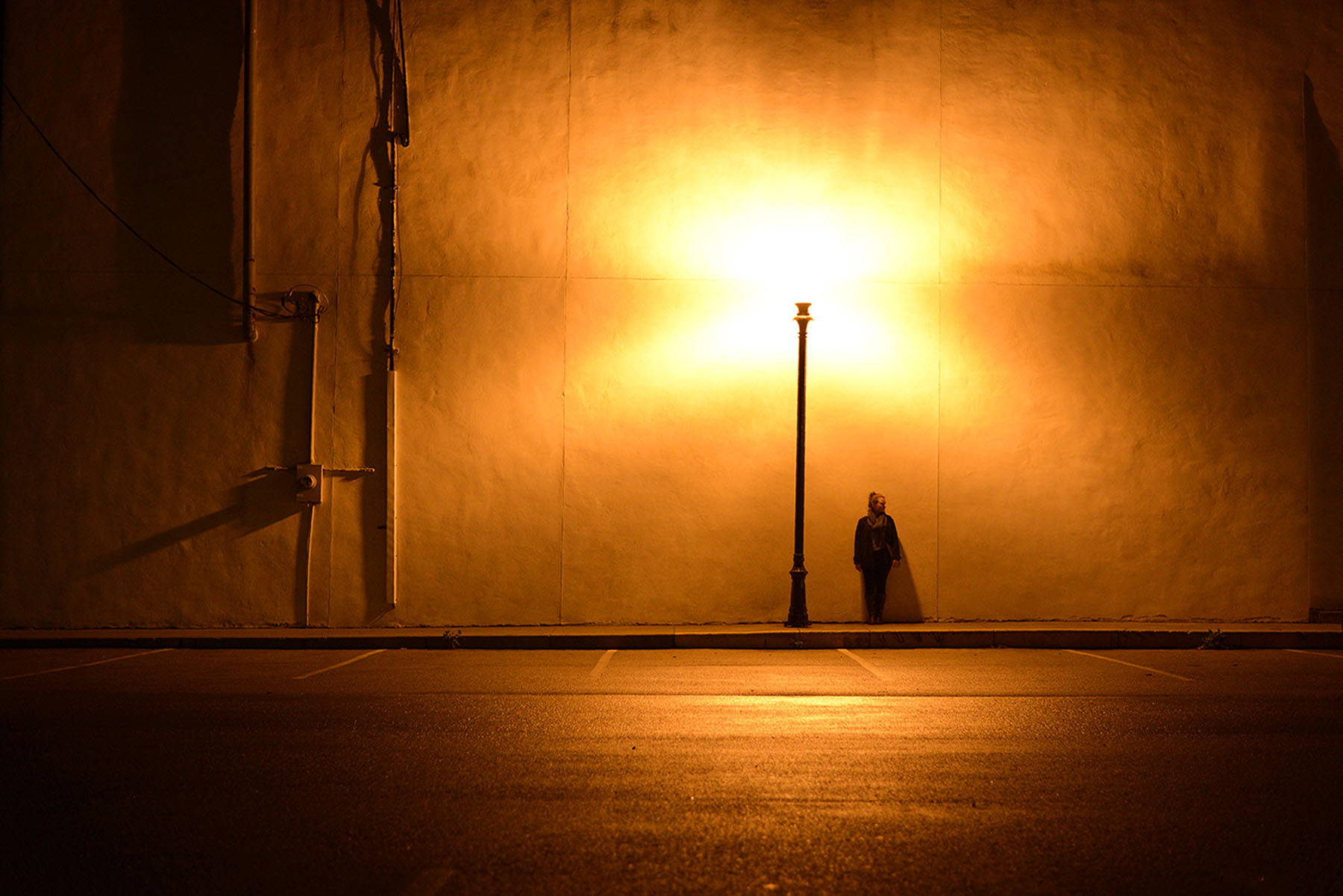  Kelly Olejnik, 22, scans the deserted alley behind the old buildings of downtown Sedalia, Mo., Friday night, Oct. 9, 2014. She’s convinced that some of the town is haunted and is determined to meet a ghost. 