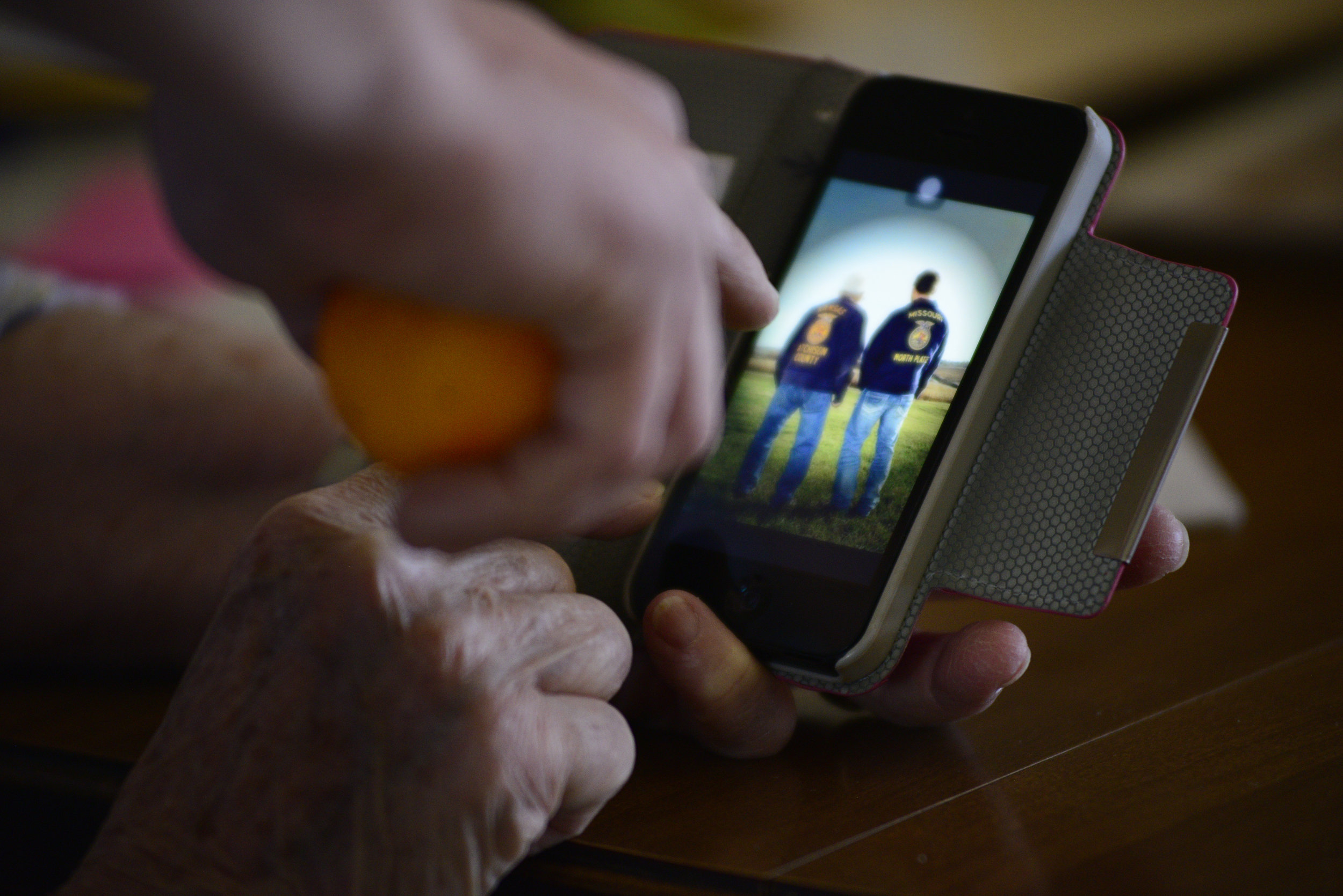  Zach and his grandmother look at a photo of himself with his grandfather wearing their Future Farmers of America jackets. Both were presidents of a local FFA chapter when they were in high school. His grandfather was the Atchison County Community Hi