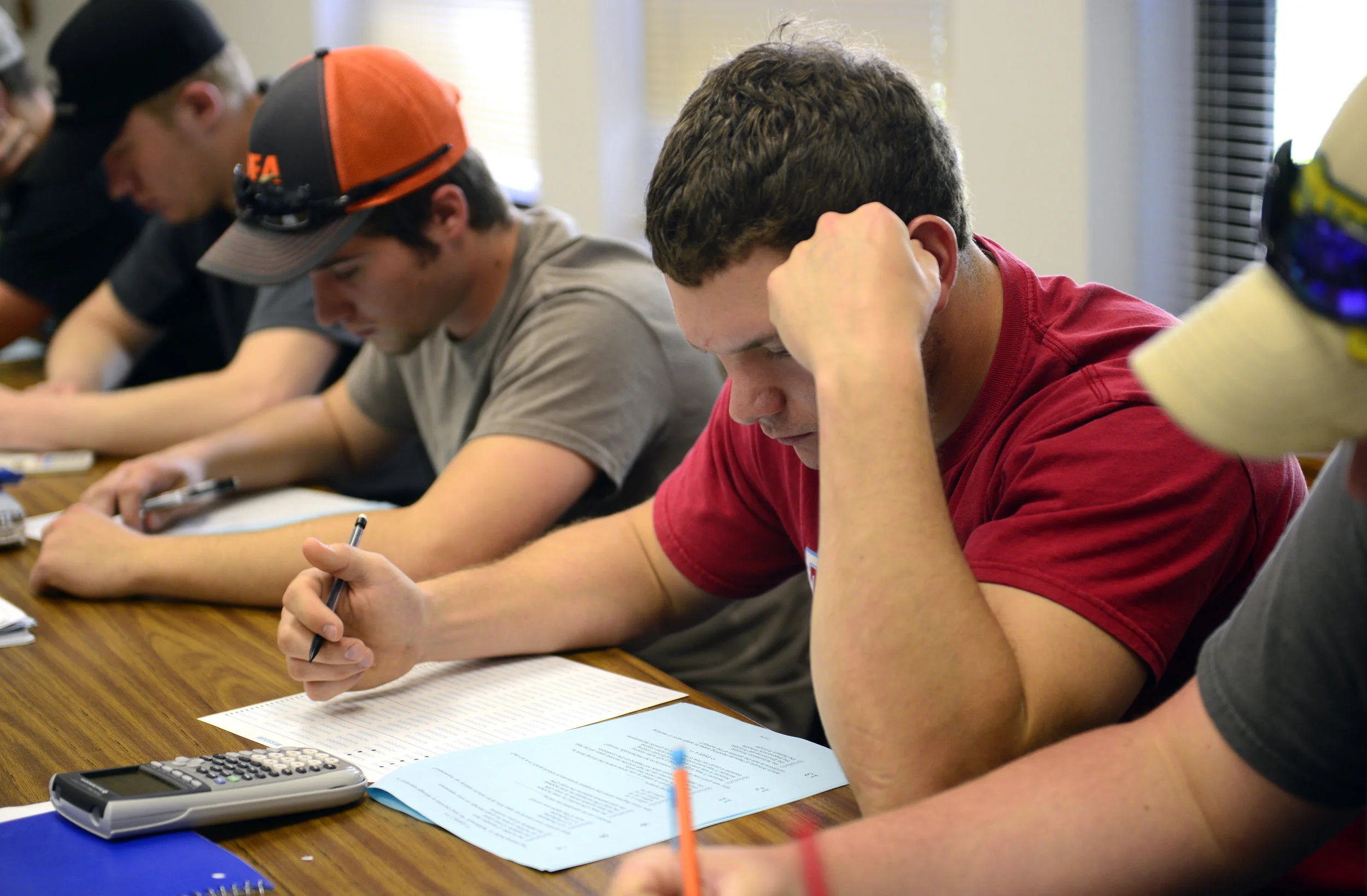  Zach reads over a question on his last exam for his Grain and Material Handling class. Zach took over the farm after his grandfather passed away, but he still had to finish up his last semester as the University of Missouri where he studied Agricult