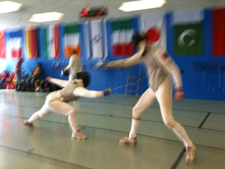 Stephanie Cole Adams fencing (left).