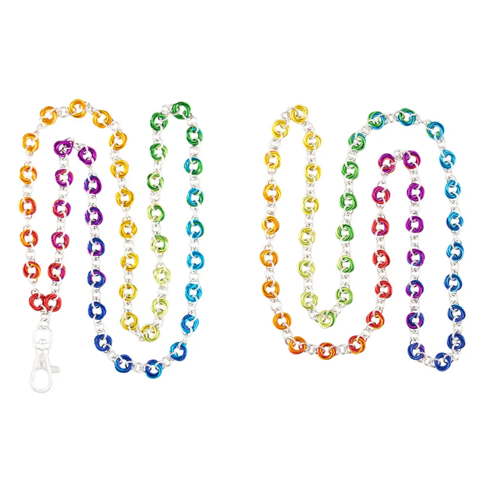 Colorful rainbow-colored chain necklaces with rainbow color patterns on a white background. Jewelry photographed by Kayla Duffney Creative.