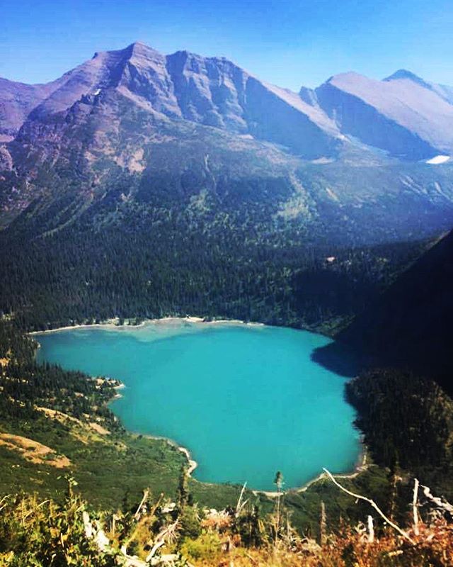 The photo is a tad smoky from the forest fires but the color of Grinnell Lake is mesmerizing. It's even more vibrant in person. The photo doesn't do it justice. Stay tuned for a full write up of our trip. #glaciernationalpark #grinnellglacierhike #ge