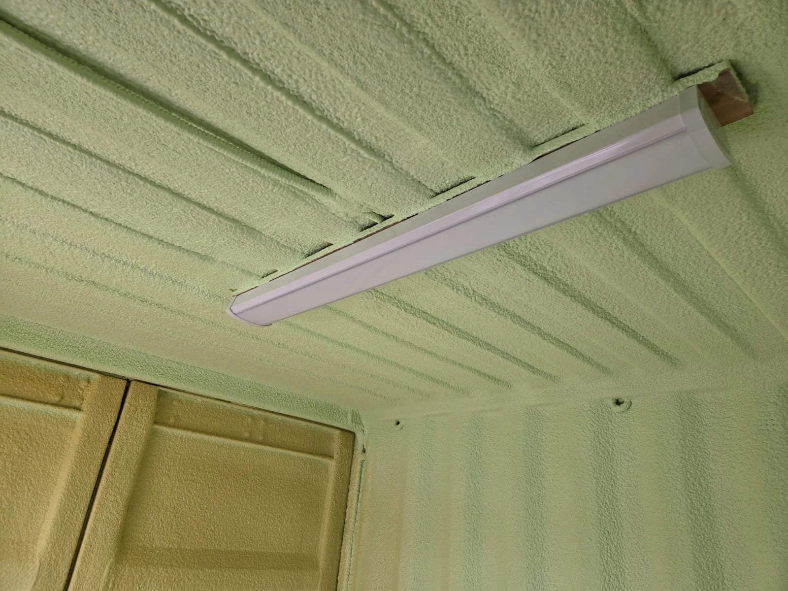 Custom insulation and lighting inside a 10-ft container office