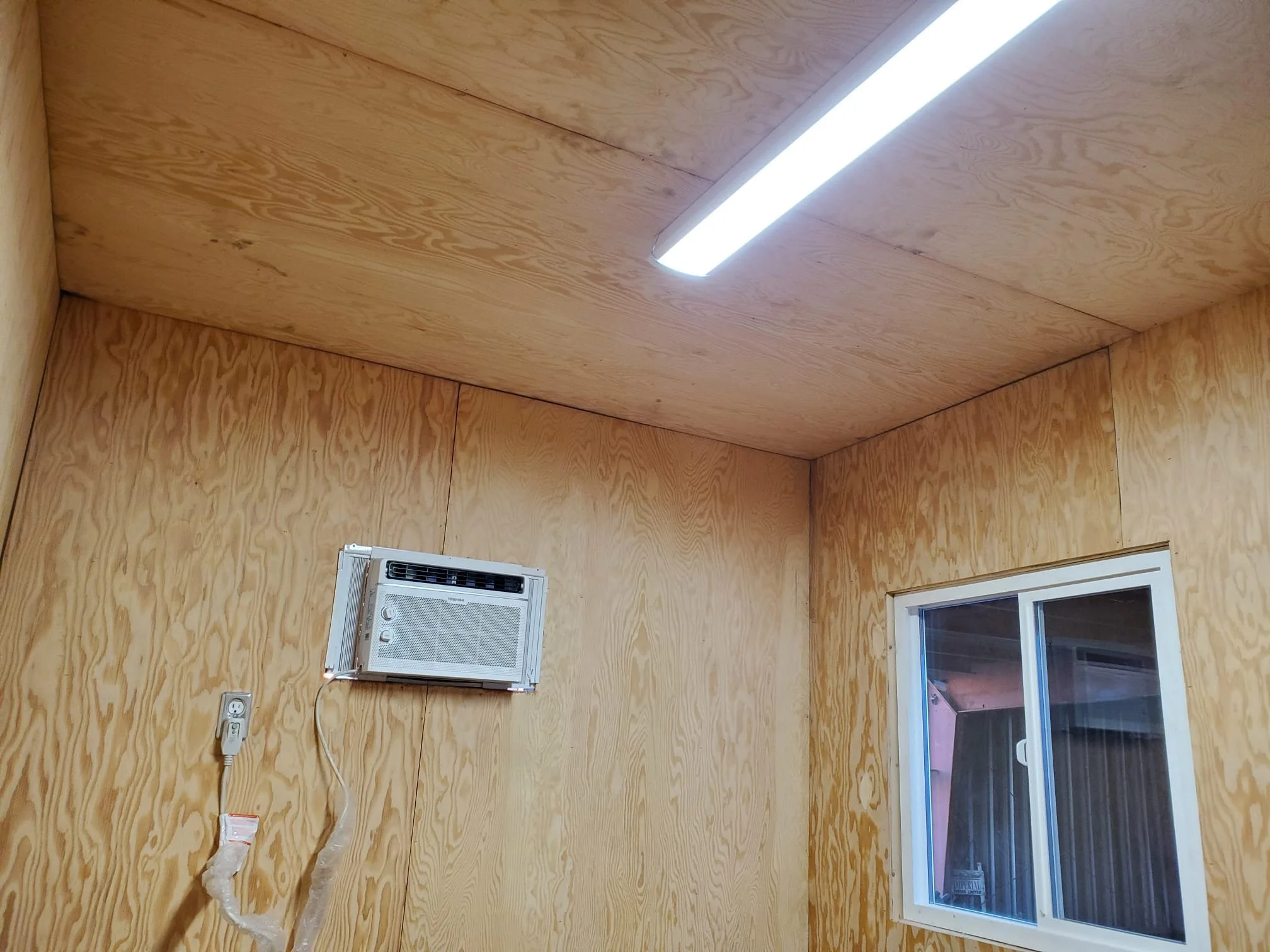 Fully outfitted 20-ft container office interior with walls, window, and electrical