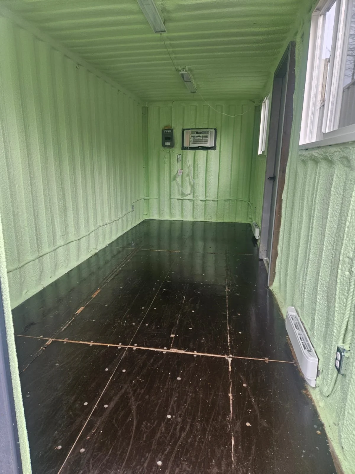 20-ft container office interior with flooring, insulation, windows, and doors