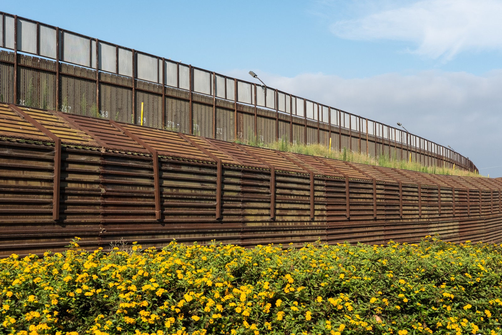 13. Hinterland - Border wall behind outlet stores, San Ysidro, CA.jpg