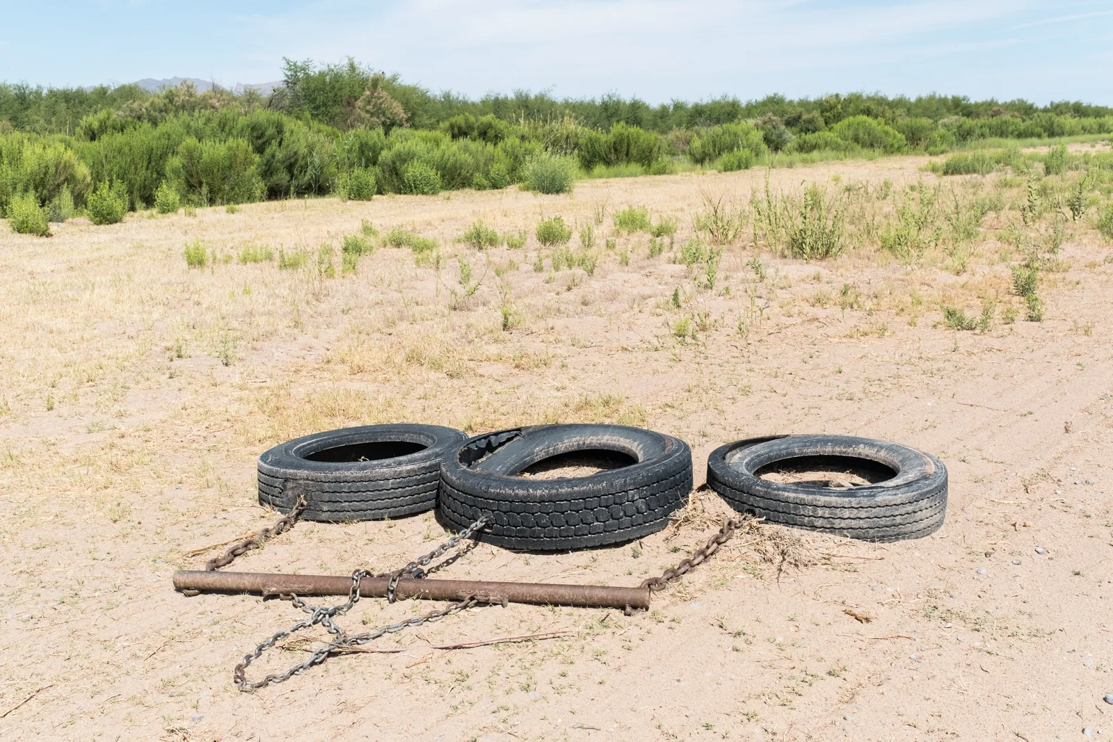 15. Hinterland - %22Pulling the drag%22, dragging tires to cover old footprints near Fort Hancock, TX.jpg