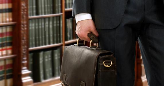 lawyer-in-library-holding-briefcase-closeup_573x300.jpg