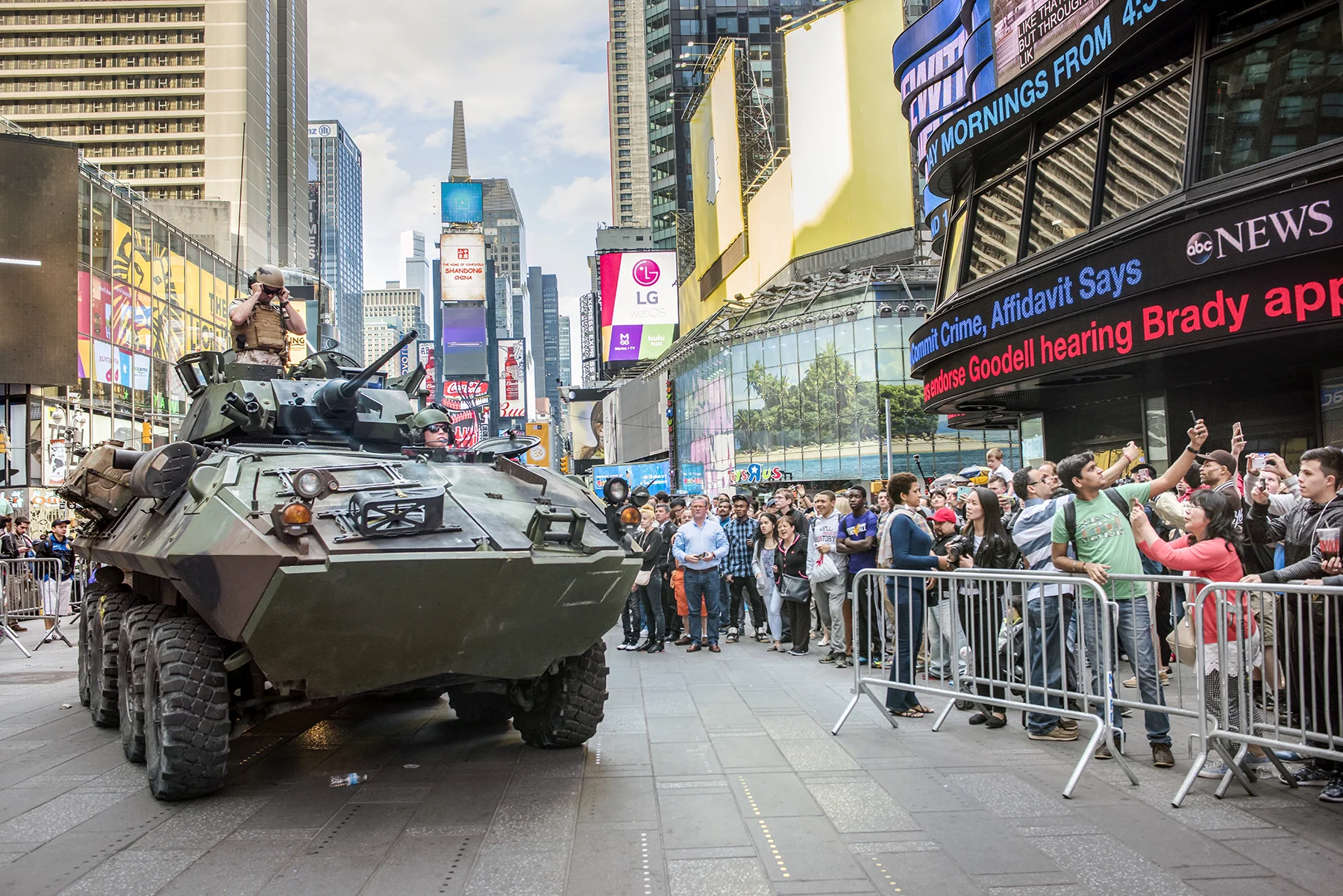 USA, New York City, May 2015, US Marines in Times Square for Fleet Week - demonstration weapons including rifles and arriving in an armored personnel carrier.