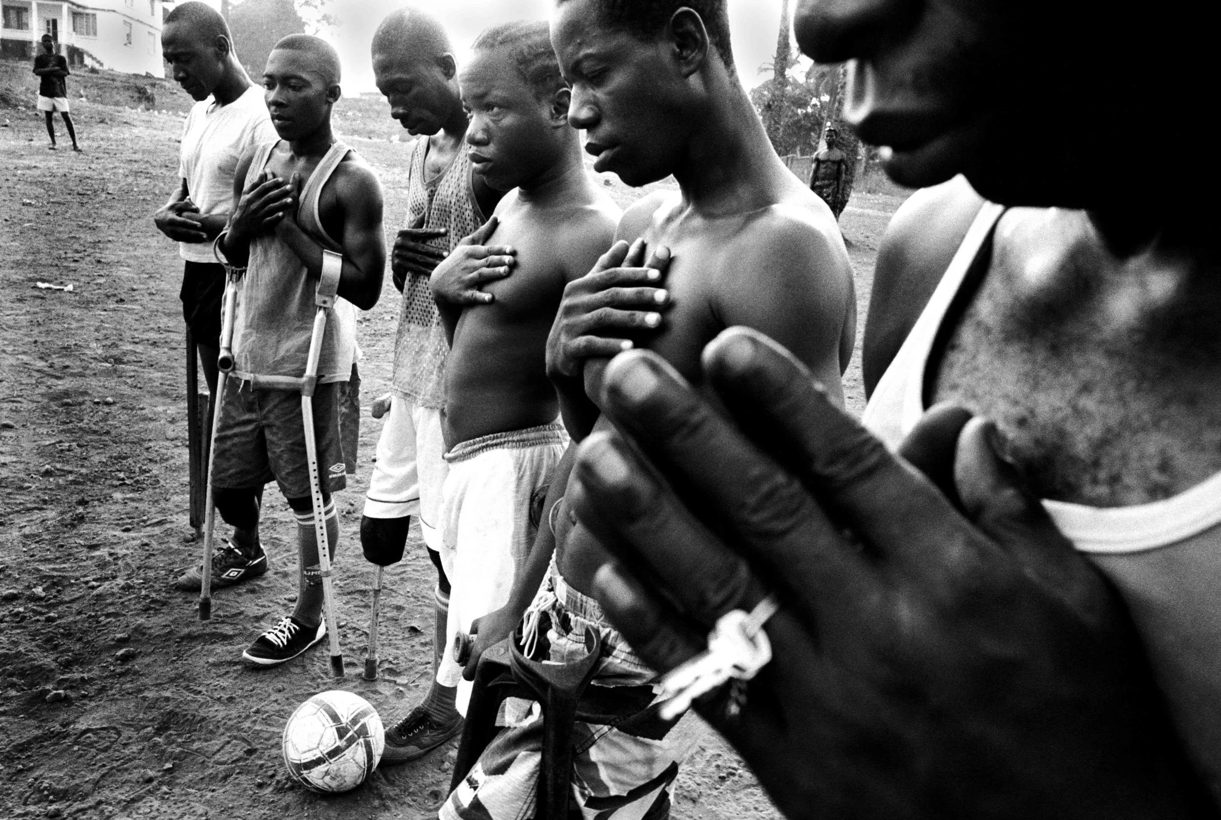 Sierra Leone, Freetown, November 2003, The team praying before the match.