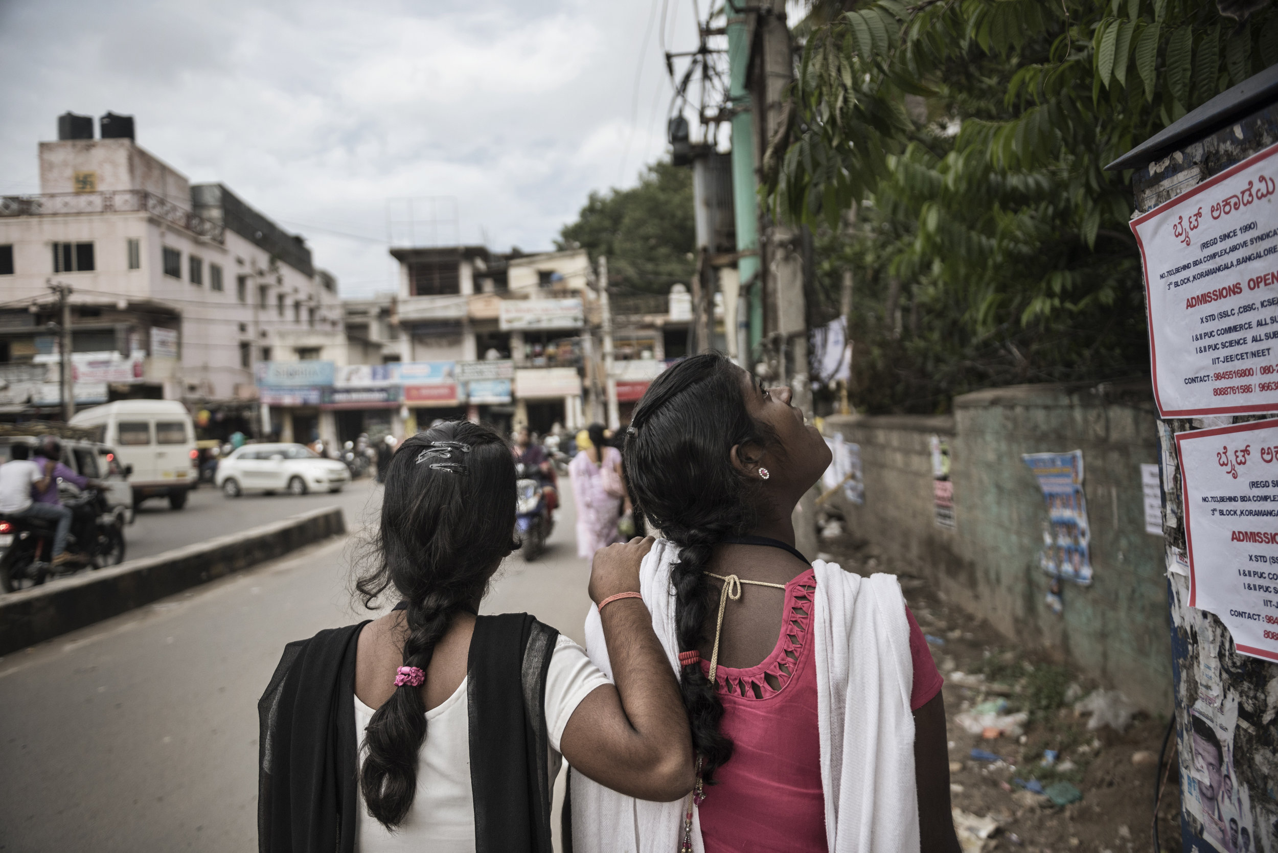 India, Bangalore, June 2016, Sisters Shashi and Prabhati, in awe of the city of Bangalore, walk from work at the factory to their dorm.