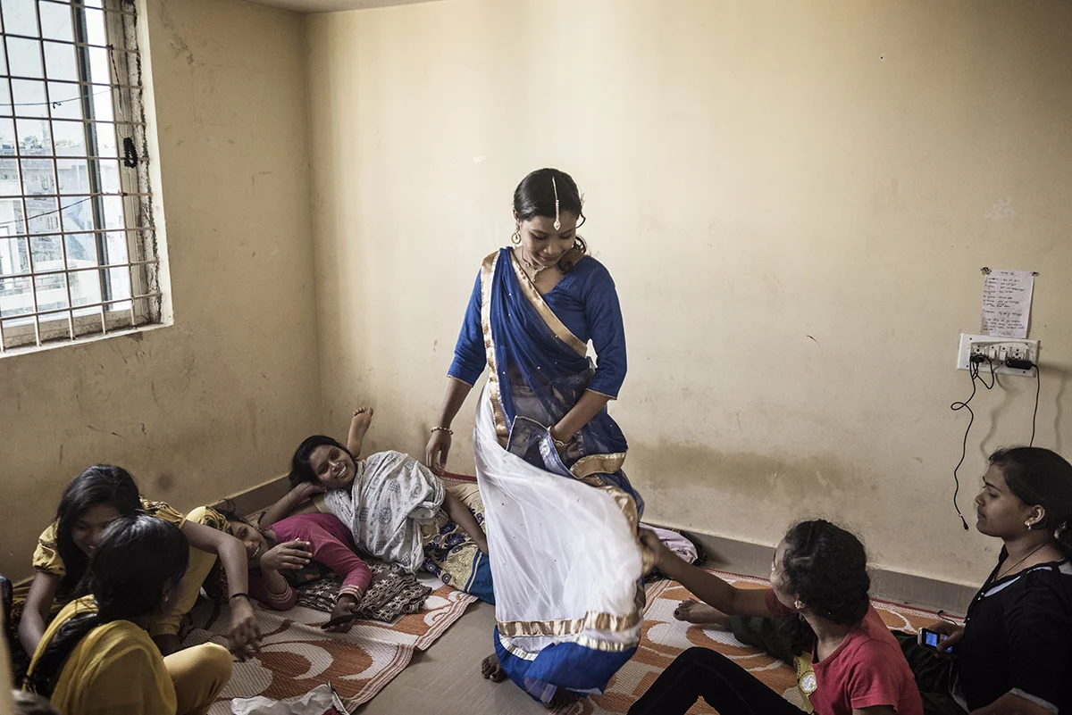 India, Bangalore, June 2016, Sima shows off a new dress and jewelry she bought with the money she made working at the clothing factory.
