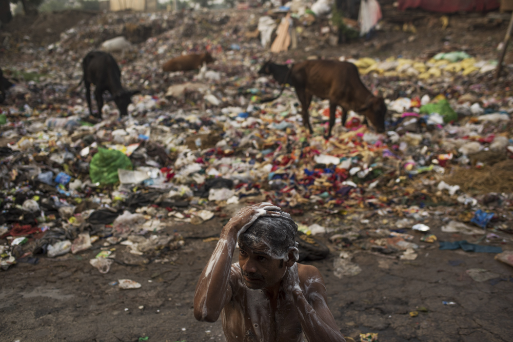  India, New Delhi, 07 October 2016

In a New Delhi slum, Sundar Kumar, 27, bathes from a well next to a garbage dump where people defecate in the open.
Open defecation may happen in India's villages more often, but it has a deeper impact on the water