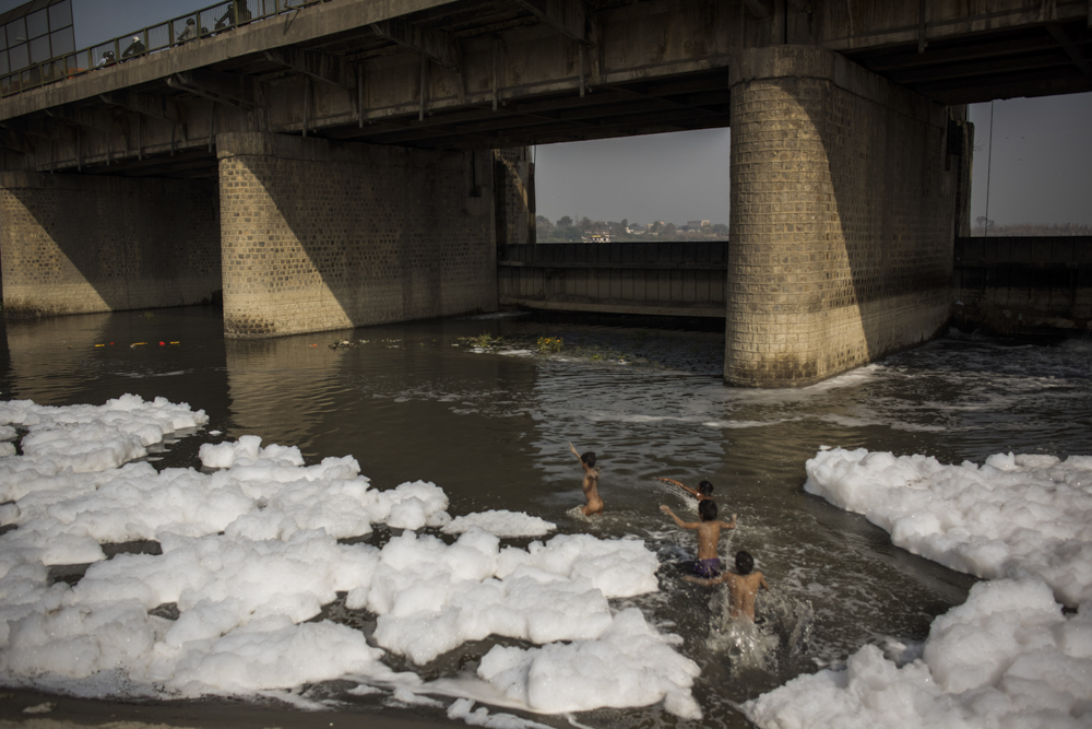  India, Delhi, Wazirabad, 08 February 2017

Prakash, 10, and Raees, 11, play in the heavily polluted Yamuna River where 18 drains from New Delhi dump 600 million gallons of sewage every year. The boys thought the bubbles were signs of soap, though ma