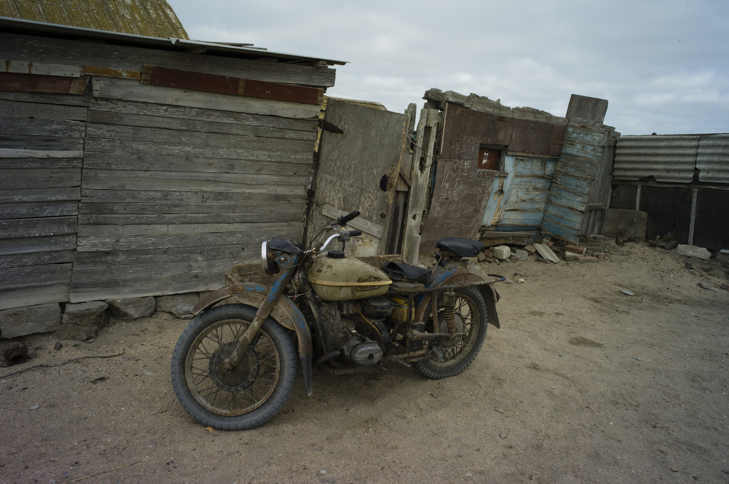  Russia, Dagestan, Chechen Island, 26 November 2013

Nicolay "Lis" which means "Fox" is fisherman who lives on the island and paints and lives among his paintings.He uses an old Russian Motorcycle to move around the Island, there are not cars, and no