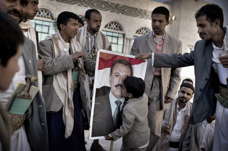  SANAA YEMEN-- MAY 2011:  A boy    kisses    a  poster of Yemen's President Ali Abdullah Saleh

 