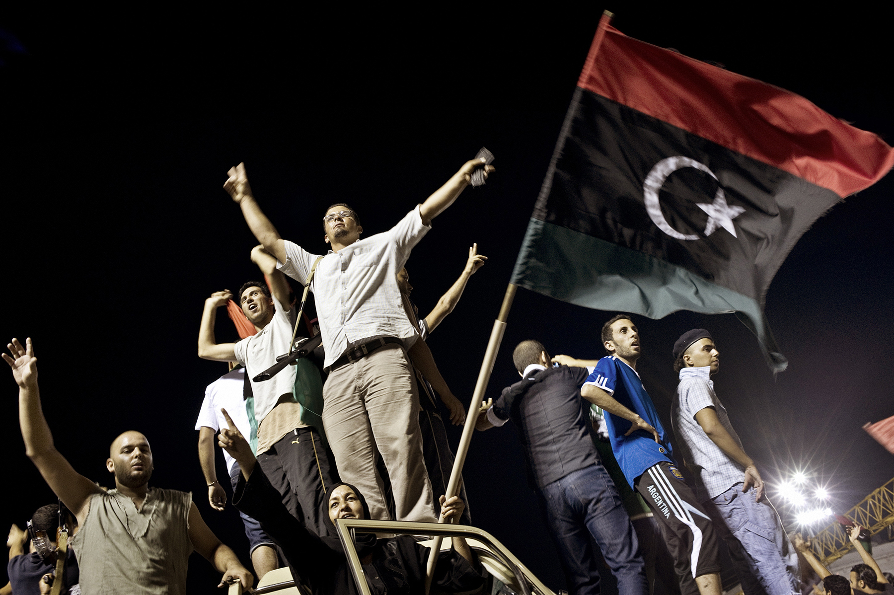  Rebels celebrate in Tripoli's iconic Green Square on August 24, 2011, shortly after breaking into Col. Muammar Gaddaf's Bab al-Aziziya compound for the first time. After six months of gruesome--yet often unmoving--front lines, the rebel victory in t
