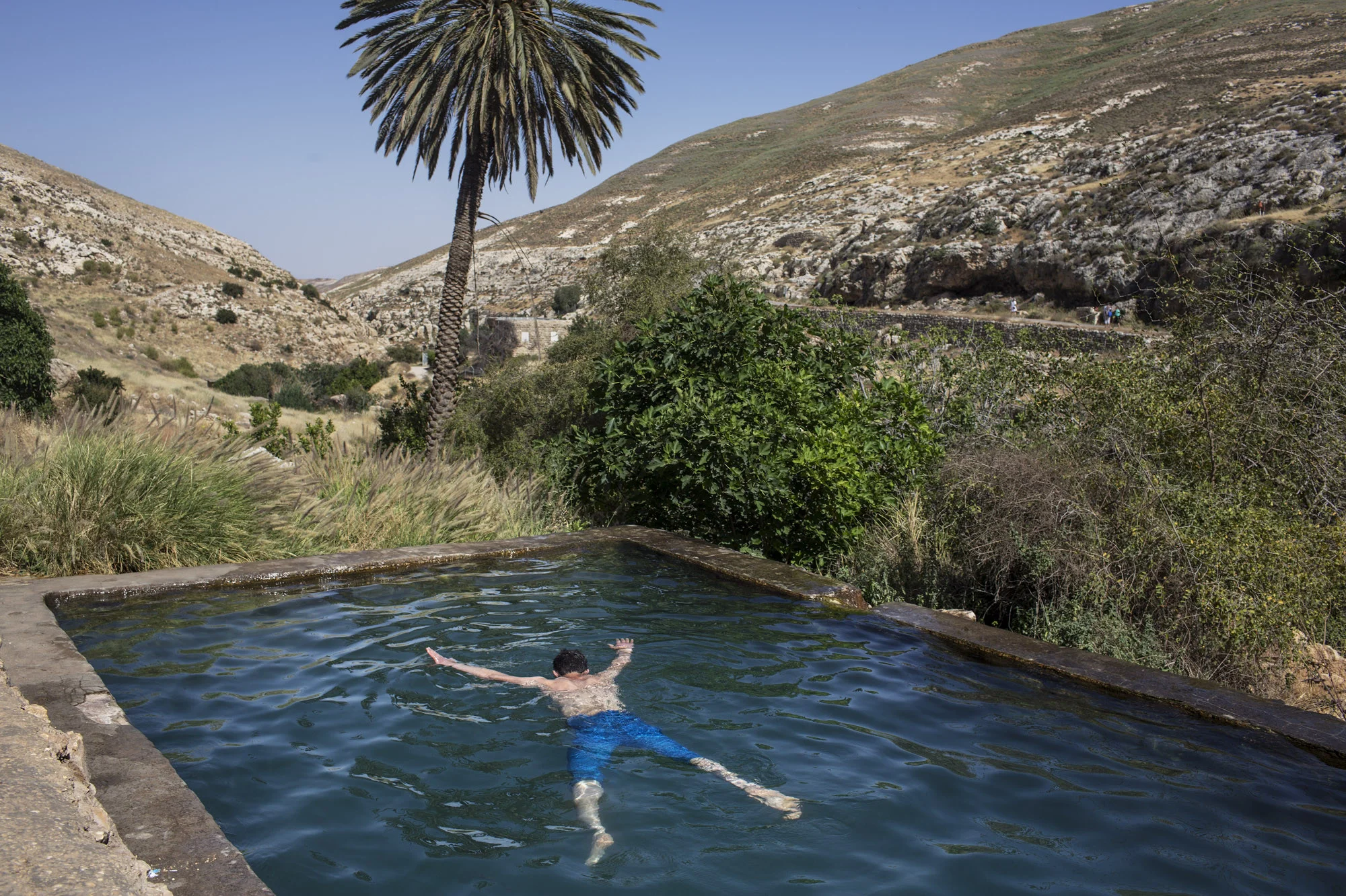 Occupied Palestinian Territories, West Bank, Ein Farah, April 2013, A Palestinian youth from Hebron enjoys a swim in Ein Farha, considered to be one of the most beautiful nature spots in the entire West Bank. It, like many other nature reserves and heritage sites, is occupied by the Israeli Nature and Parks Authority. Palestinian tourist enterprises are not allowed.