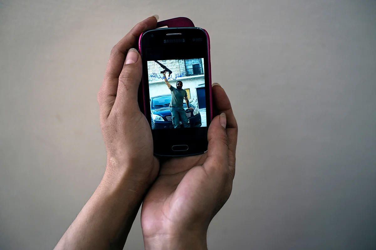 When her husband was alive, he would send "Aysha" sultry texts, poems, and fighter images from the front lines. It was by text message she found out that he died while fighting in Syria. When her old nokia died, she lost her trove of memories. This is the only image she has from that time before his death.