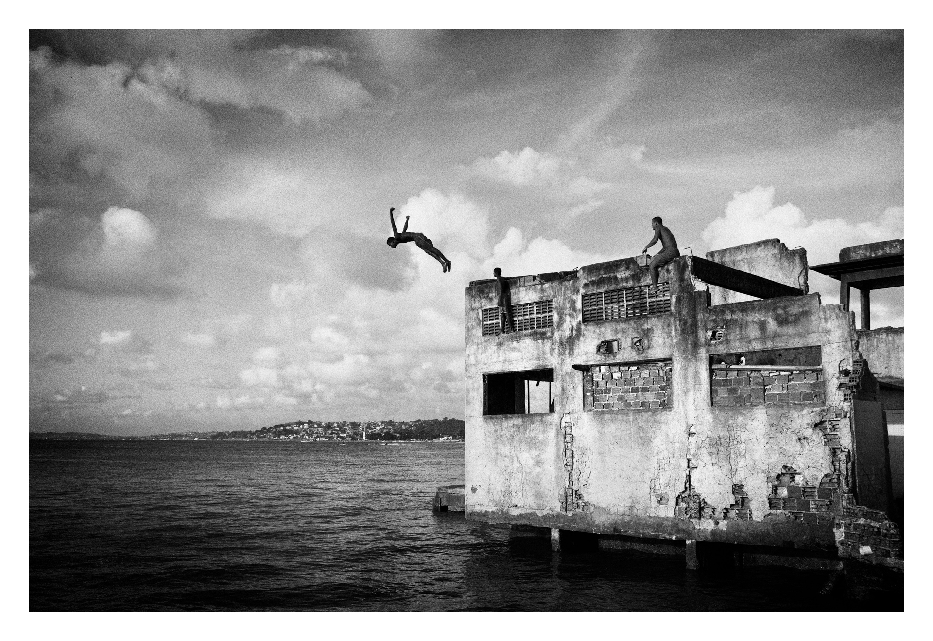  SALVADOR DE BAHIA, BRAZIL ? MARCH 20, 2011: A boy jumping from a building of the abandoned chocolate factory, on March 20, 2011 in Salvador de Bahia, Brazil. Despite the lack of socio-economic support from the government, they have managed to make a